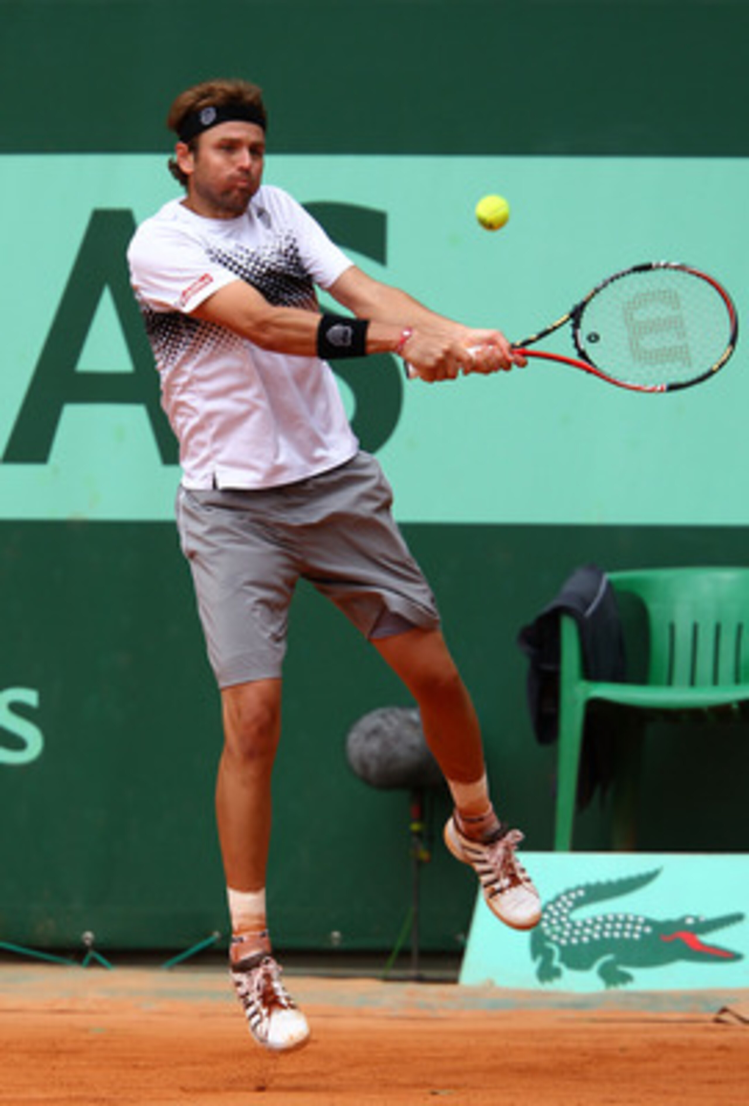 PARIS, FRANCE - MAY 26:  Mardy Fishof USA hits a backhand during the Men's singles round two match between Mardy Fish of USA and Robin Haase of Netherlands on day five of the French Open at Roland Garros on May 26, 2011 in Paris, France.  (Photo by Clive