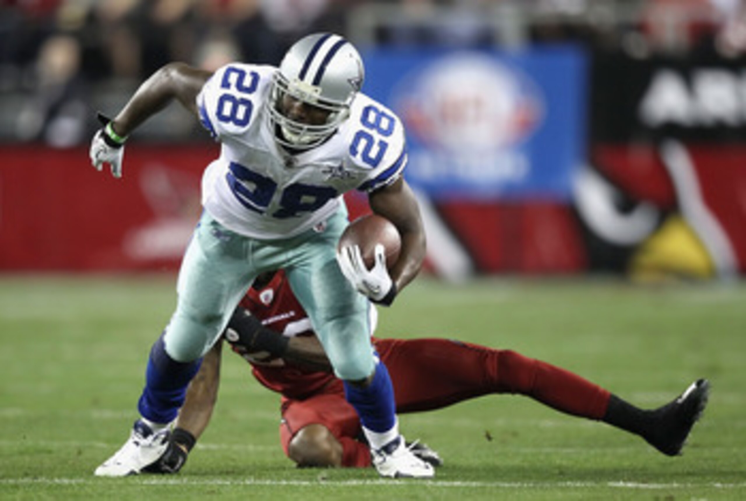 GLENDALE, AZ - DECEMBER 25:  Runningback Felix Jones #28 of the Dallas Cowboys runs with the football during the NFL game against the Arizona Cardinals at the University of Phoenix Stadium on December 25, 2010 in Glendale, Arizona.  The Cardinals defeated