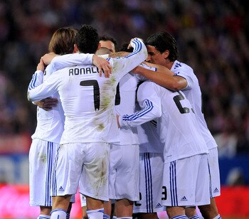 MADRID, SPAIN - MARCH 19: Cristiano Ronaldo celebrates with team mates after Mesut Ozil scored their scored goal during the La Liga match between Atletico Madrid and Real Madrid at Vicente Calderon Stadium on March 19, 2011 in Madrid, Spain.  (Photo by De