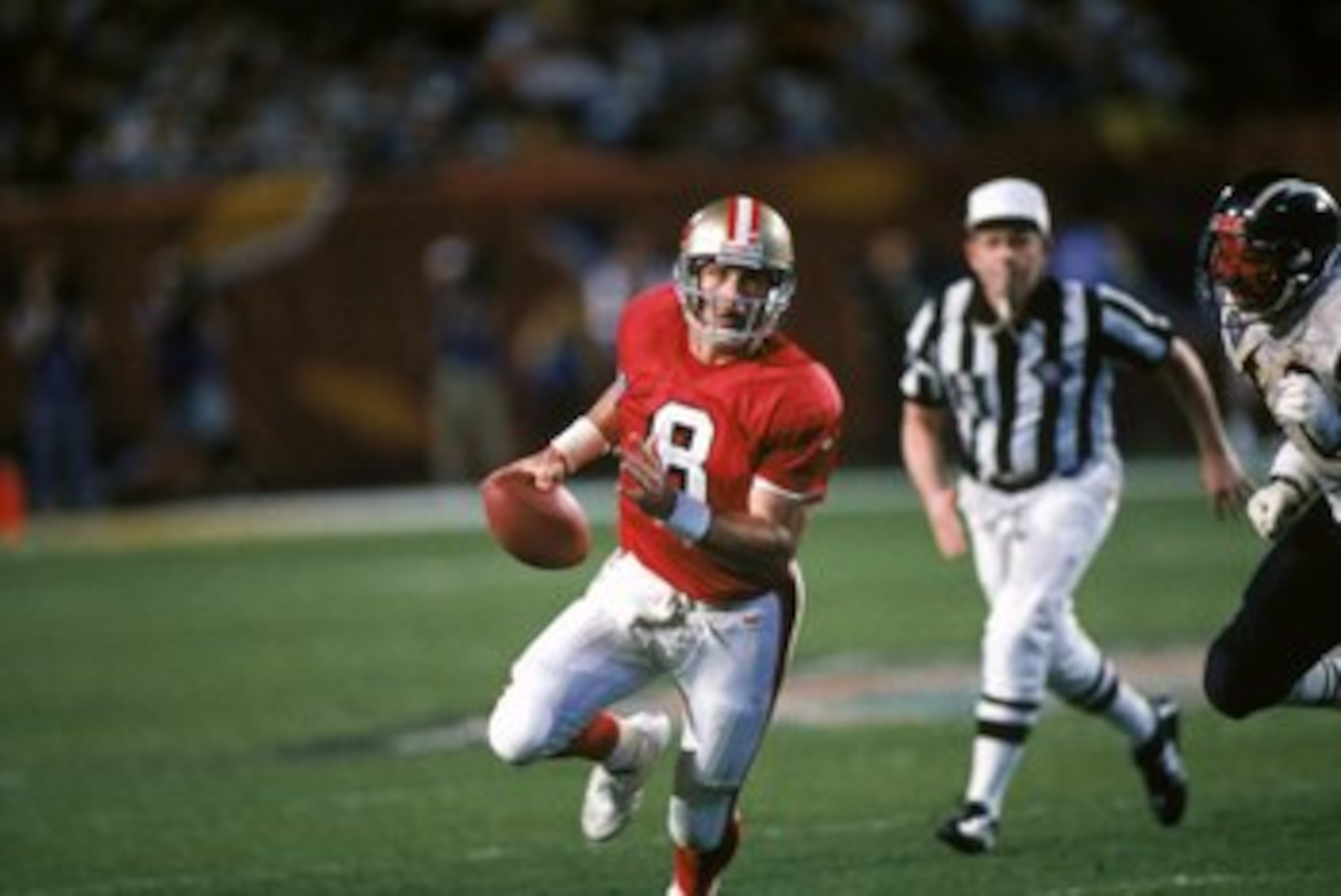 MIAMI - JANUARY 29:  Quarterback Steve Young #8 of the San Francisco 49ers finds room to run with the ball during Super Bowl XXIX against the San Diego Chargers at Joe Robbie Stadium on January 29, 1995 in Miami, Florida. The 49ers won 49-26. (Photo by Ge