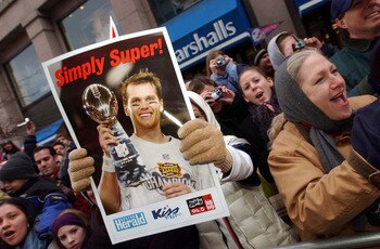 BOSTON, MA - FEBRUARY 3:  A New England Patriots fan holds a poster of quarterback and Super Bowl MVP Tom Brady during a victory parade February 3, 2004 in Boston, Massachusetts. The Patriots celebrated their second championship in three years today with