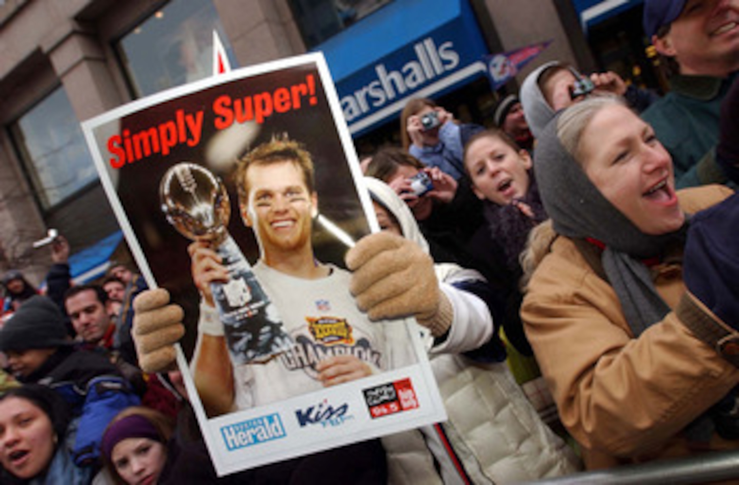 BOSTON, MA - FEBRUARY 3:  A New England Patriots fan holds a poster of quarterback and Super Bowl MVP Tom Brady during a victory parade February 3, 2004 in Boston, Massachusetts. The Patriots celebrated their second championship in three years today with