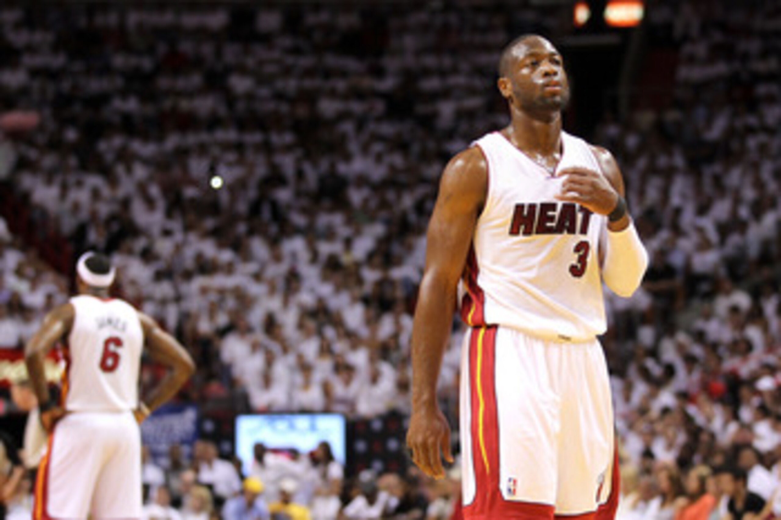 MIAMI, FL - MAY 24:  Dwyane Wade #3 of the Miami Heat looks on as LeBron James #6 stands in the background against the Chicago Bulls in Game Four of the Eastern Conference Finals during the 2011 NBA Playoffs on May 24, 2011 at American Airlines Arena in M