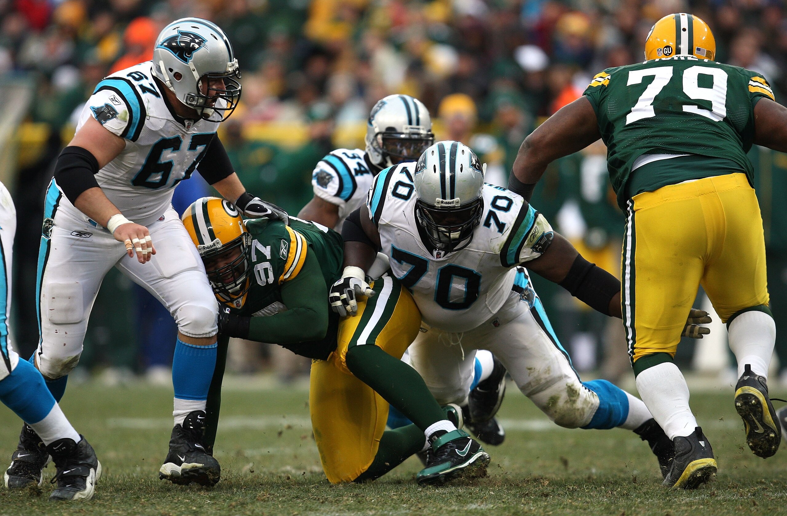 GREEN BAY, WI - NOVEMBER 30: Travelle Wharton #70 and Ryan Kalil #67 of the Carolina Panthers block against the Green Bay Packers at Lambeau Field on November 30, 2008 in Green Bay, Wisconsin. The Panthers won 35-31. (Photo by Jonathan Daniel/Getty Ima GREEN BAY, WI - NOVEMBER 30: Travelle Wharton #70 and Ryan Kalil #67 of the Carolina Panthers block against the Green Bay Packers at Lambeau Field on November 30, 2008 in Green Bay, Wisconsin. The Panthers won 35-31. (Photo by Jonathan Daniel/Getty Ima