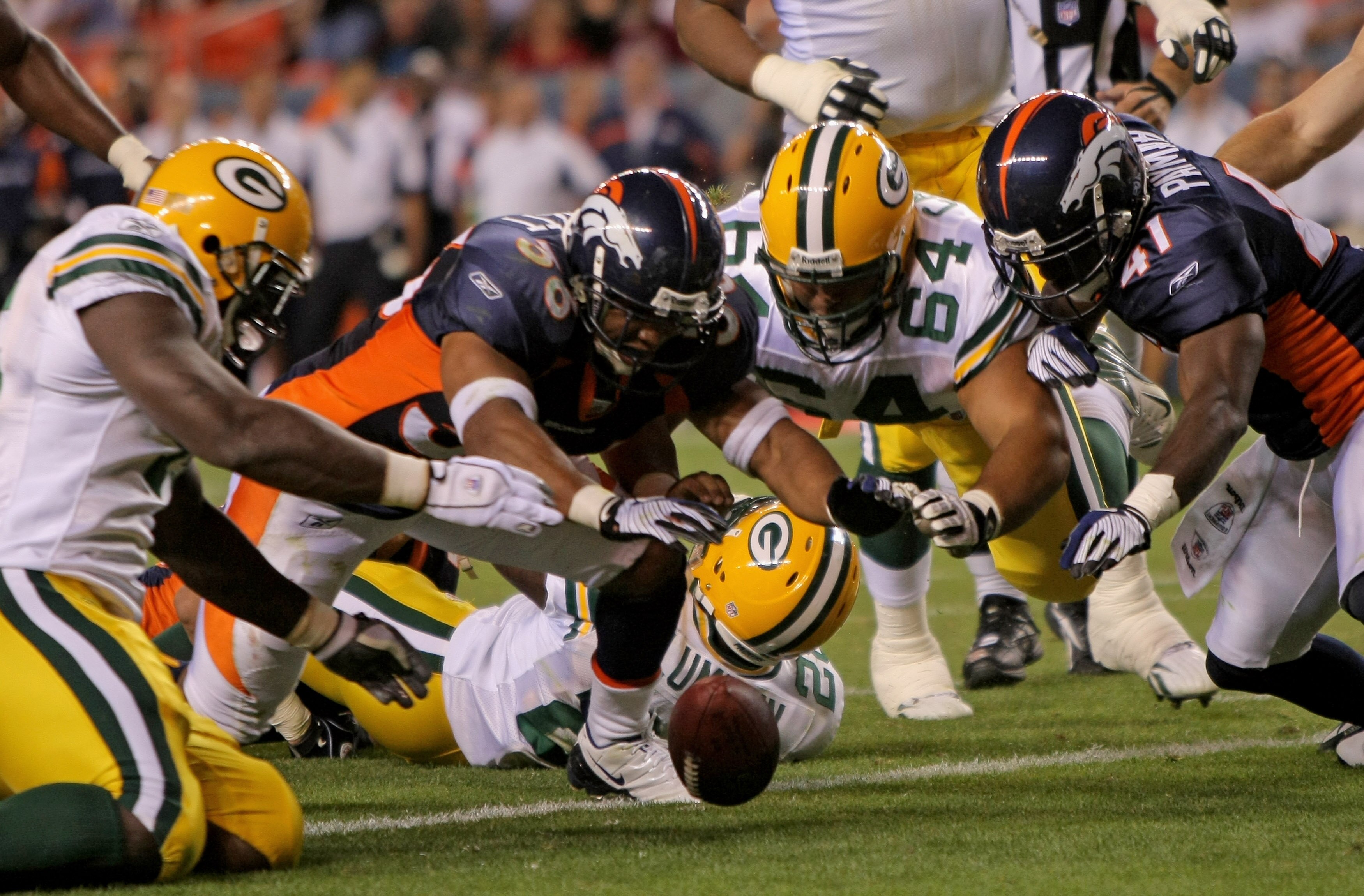 DENVER - AUGUST 22:  (L-R) Corey White #45 of the Packers, Josh Barrett #36 of the Broncos, Brennen Carvalho #63 of the Packer and Karl Paymah #41 of the Broncos pursue a loose ball in the endzone ruled down by contact after Kregg Lumpkin of the Green Bay