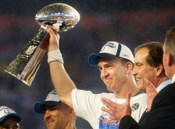 MIAMI GARDENS, FL - FEBRUARY 04:  Quarterback Peyton Manning #18 of the Indianapolis Colts celebrates with the Vince Lombardi Super Bowl trophy after winning the Super Bowl XLI 29-17 over the Chicago Bears on February 4, 2007 at Dolphin Stadium in Miami G