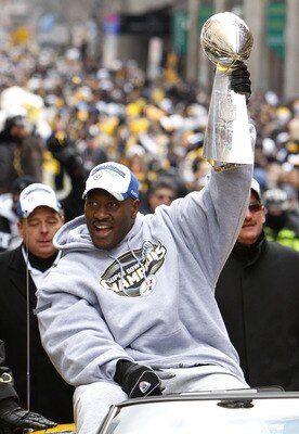 PITTSBURGH - FEBRUARY 03:  James Harrison #92 of the Pittsburgh Steelers shows off the Super Bowl XLIII trophy during a parade on February 3, 2009 in Pittsburgh, Pennsylvania.  (Photo by Gregory Shamus/Getty Images)