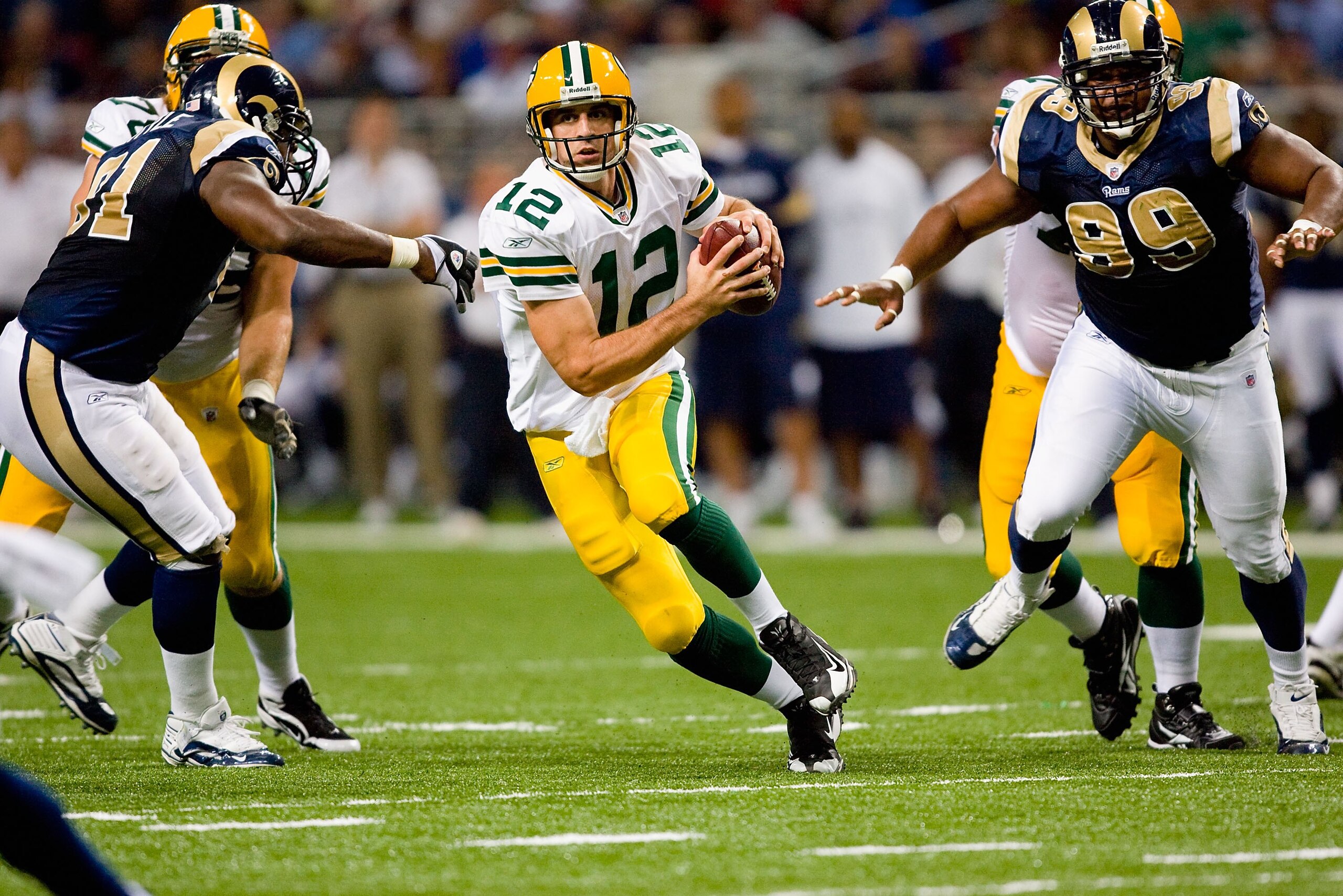 ST. LOUIS, MO - SEPTEMBER 27: Aaron Rodgers #12 of the Green Bay Packers scrambles against Leonard Little #91 and LaJuan Ramsey #99 of the St. Louis Rams during the game at the Edward Jones Dome on September 27, 2009 in St. Louis, Missouri. (Photo by Di ST. LOUIS, MO - SEPTEMBER 27: Aaron Rodgers #12 of the Green Bay Packers scrambles against Leonard Little #91 and LaJuan Ramsey #99 of the St. Louis Rams during the game at the Edward Jones Dome on September 27, 2009 in St. Louis, Missouri. (Photo by Di