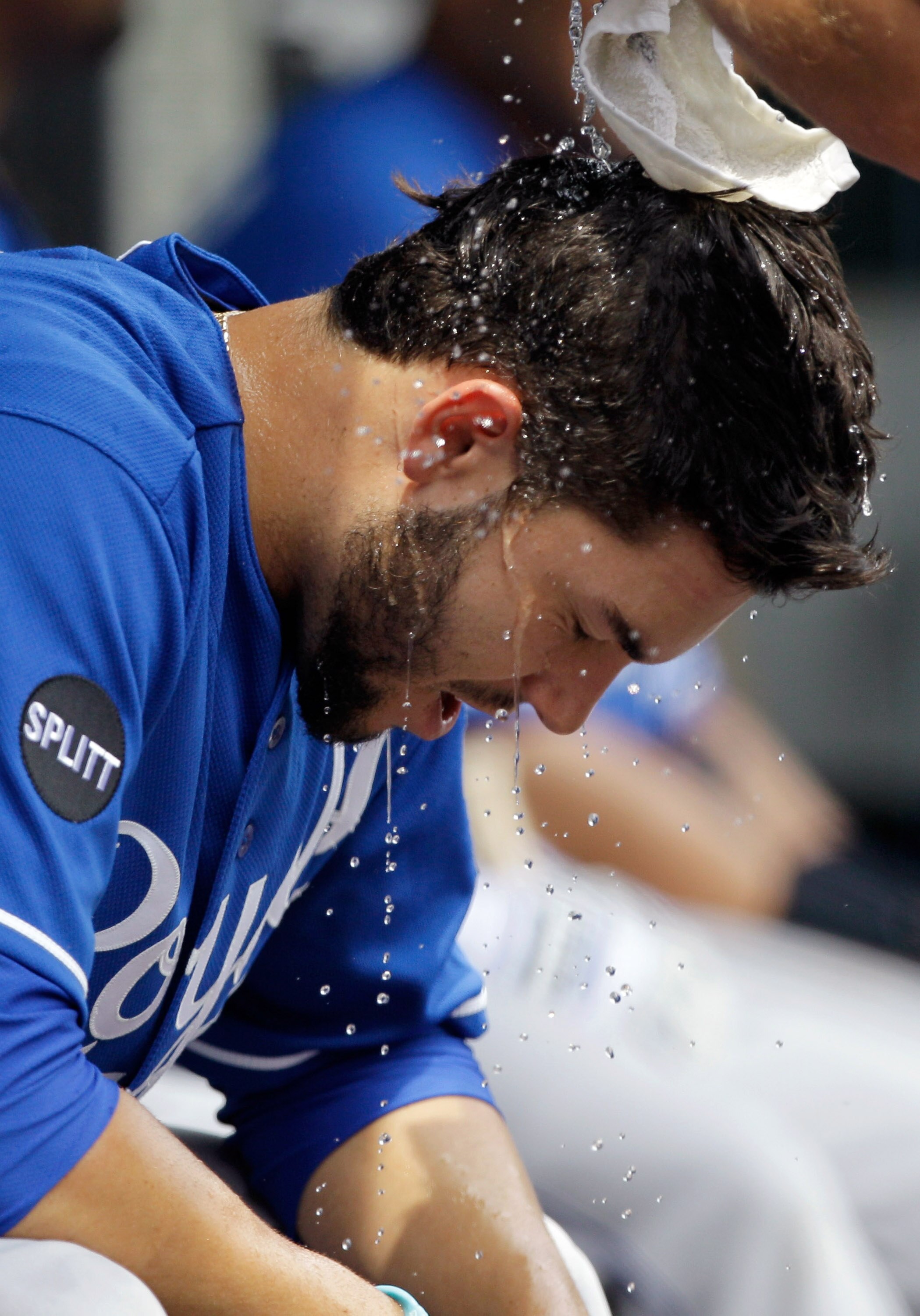 BALTIMORE, MD - MAY 26: Eric Hosmer #35 of the Kansas City Royals has water poured on his head by a trainer between innings against the Baltimore Orioles  at Oriole Park at Camden Yards on May 26, 2011 in Baltimore, Maryland.  (Photo by Rob Carr/Getty Ima