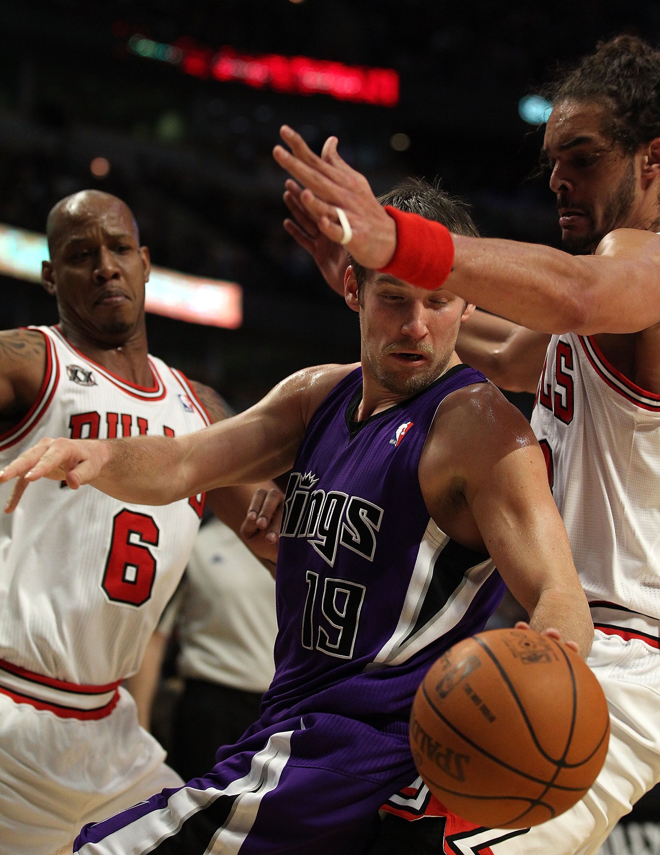 CHICAGO, IL - MARCH 21: Beno Udrih #19 of the Sacramento Kings tries to moves under pressure from Joakim Noah #13 and Keith Bogans #6 of the Chicago Bulls at the United Center on March 21, 2011 in Chicago, Illinois. The Bulls defeated the Kings 132-92. NO