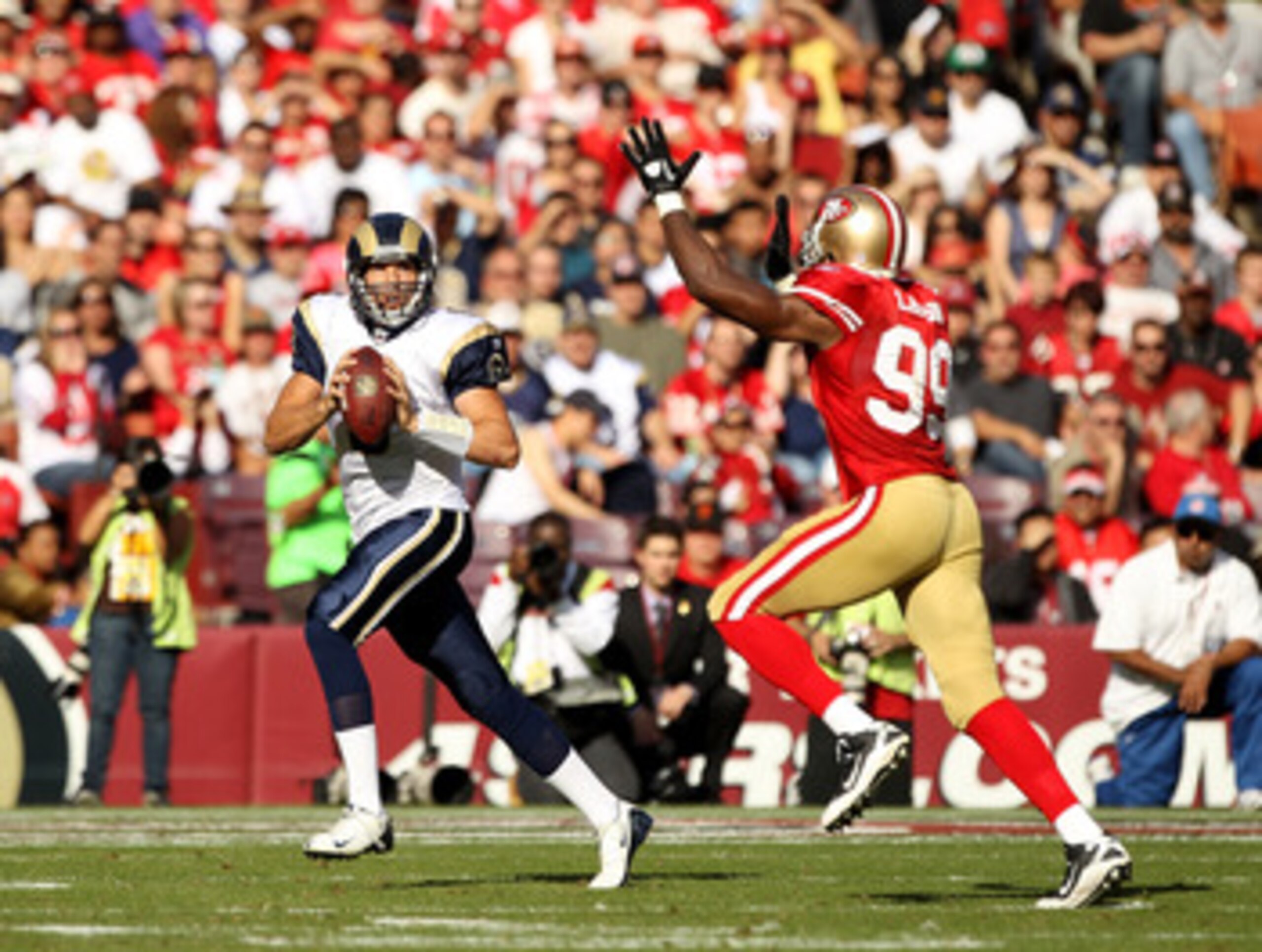 SAN FRANCISCO - NOVEMBER 14:  Sam Bradford #8  of the St. Louis Rams is chased by Manny Lawson #99 of the San Francisco 49ers at Candlestick Park on November 14, 2010 in San Francisco, California.  (Photo by Ezra Shaw/Getty Images)