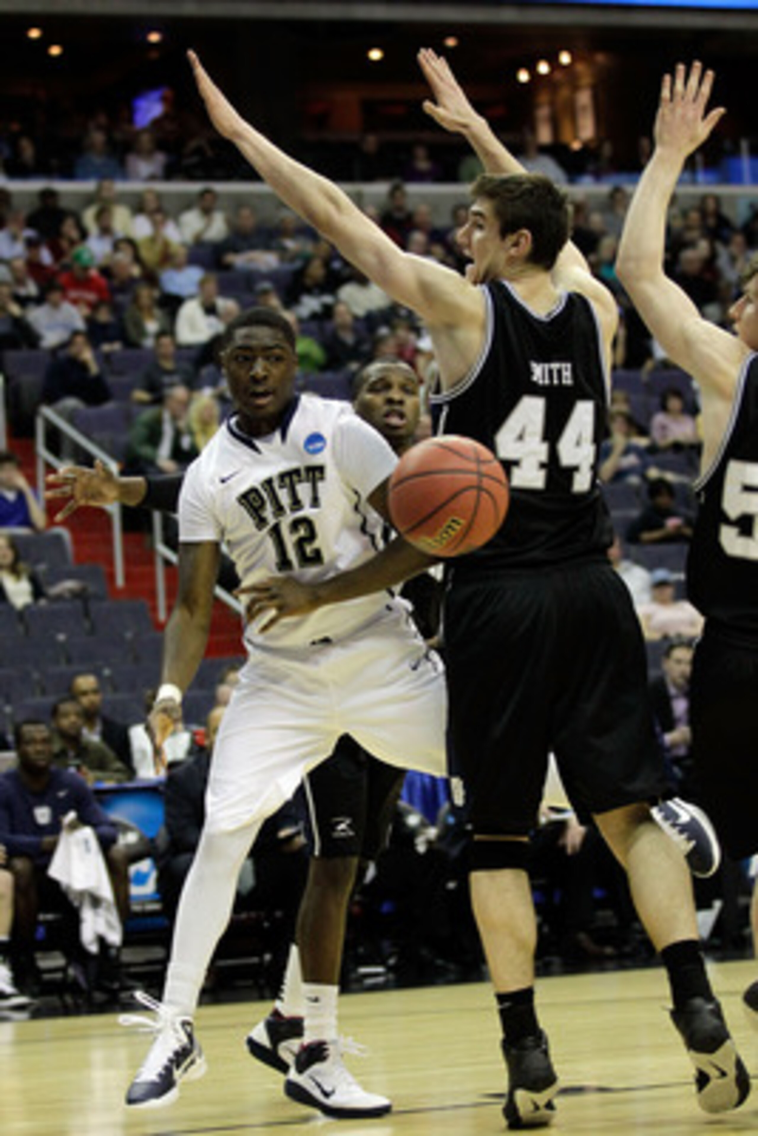 WASHINGTON - MARCH 19:  Ashton Gibbs #12 of the Pittsburgh Panthers passes around Andrew Smith #44 of the Butler Bulldogs during the third round of the 2011 NCAA men's basketball tournament at Verizon Center on March 19, 2011 in Washington, DC.  (Photo by
