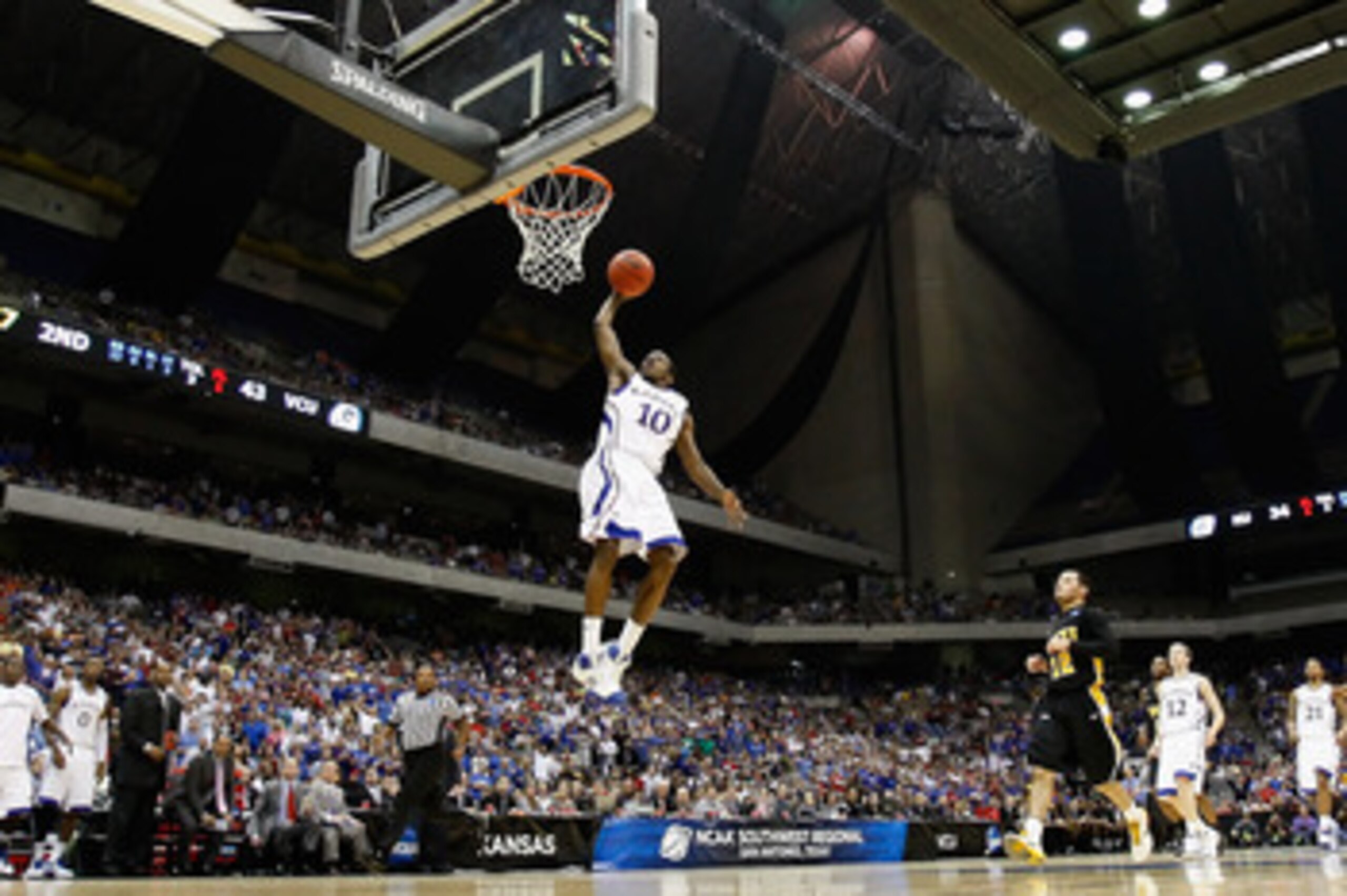 SAN ANTONIO, TX - MARCH 27:  Tyshawn Taylor #10 of the Kansas Jayhawks dunks against the Virginia Commonwealth Rams during the southwest regional final of the 2011 NCAA men's basketball tournament at the Alamodome on March 27, 2011 in San Antonio, Texas. 