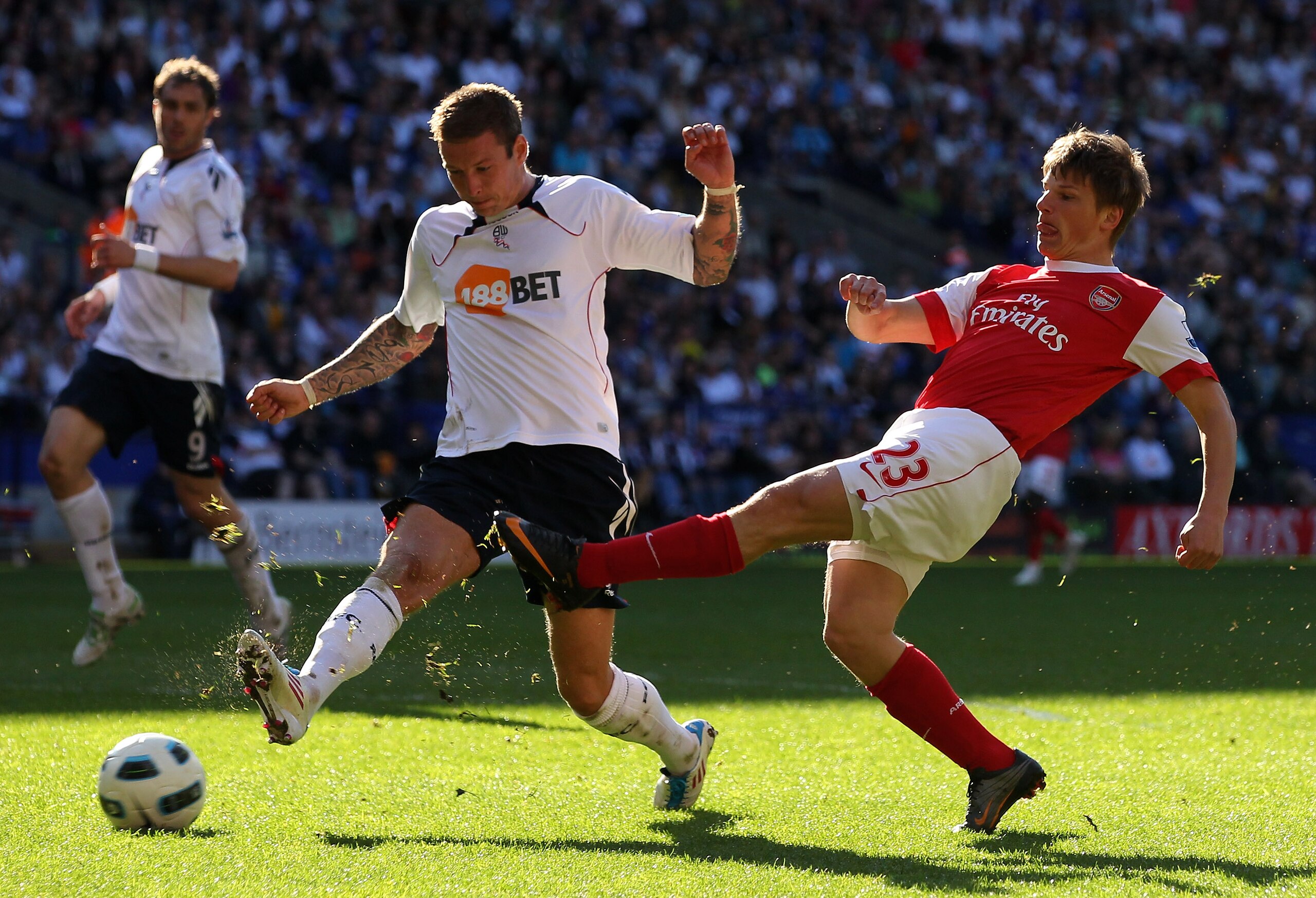 BOLTON, ENGLAND - APRIL 24:  Gretar Steinsson of Bolton Wanderers competes with Andrey Arshavin of Arsenal during the Barclays Premier League match between Bolton Wanderers and Arsenal at the Reebok Stadium on April 24, 2011 in Bolton, England. (Photo by
