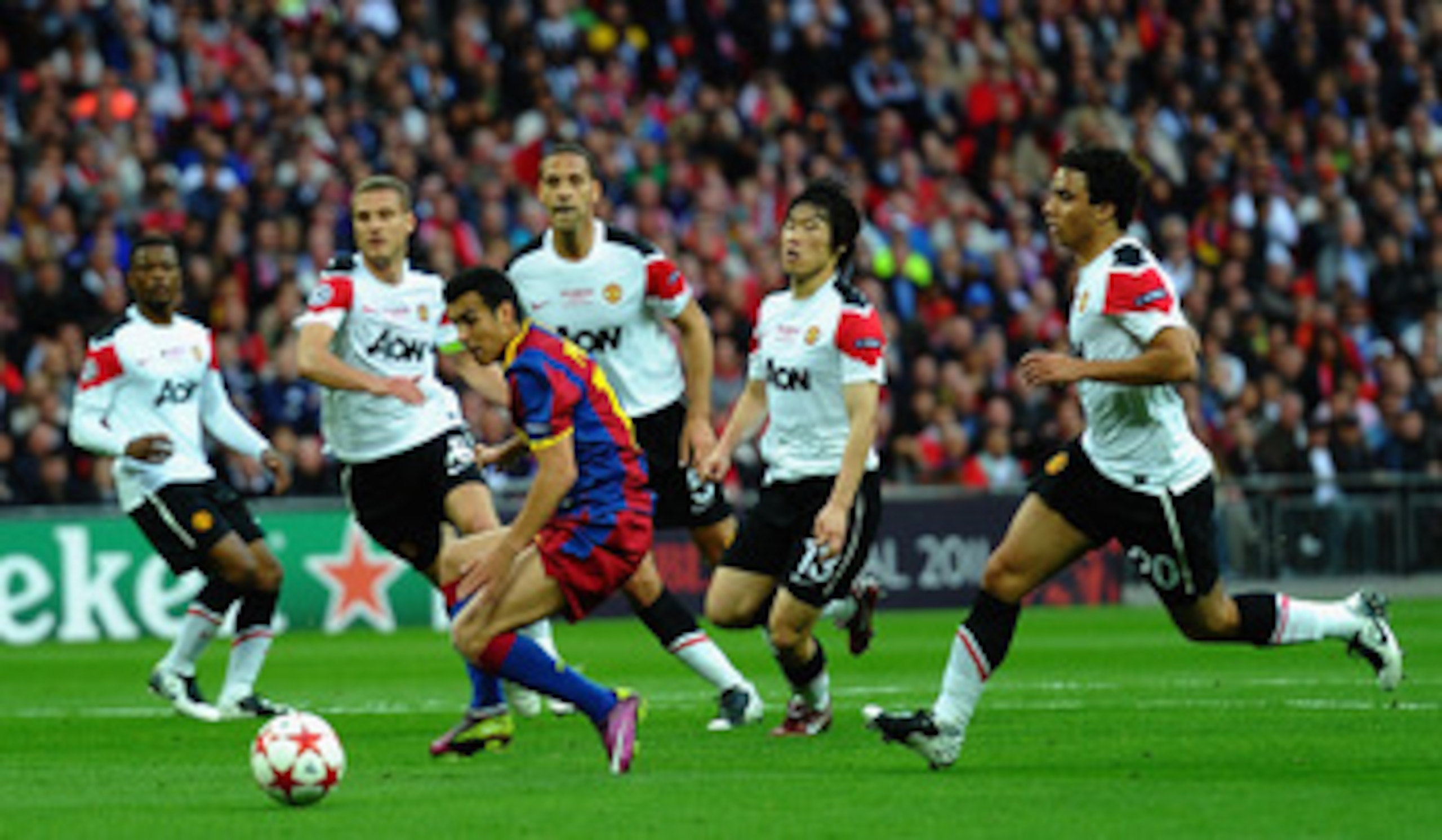 LONDON, ENGLAND - MAY 28: Pedro of FC Barcelona controls the ball as the Manchester United defense look on  during the UEFA Champions League final between FC Barcelona and Manchester United FC at Wembley Stadium on May 28, 2011 in London, England.  (Photo