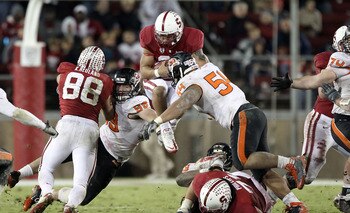PALO ALTO, CA - NOVEMBER 27:  Tyler Gaffney #25 of the Stanford Cardinal jumps in the air as he is hit by Stephen Paea #54 and Gabe Miller #99 of the Oregon State Beavers at Stanford Stadium on November 27, 2010 in Palo Alto, California.  (Photo by Ezra S