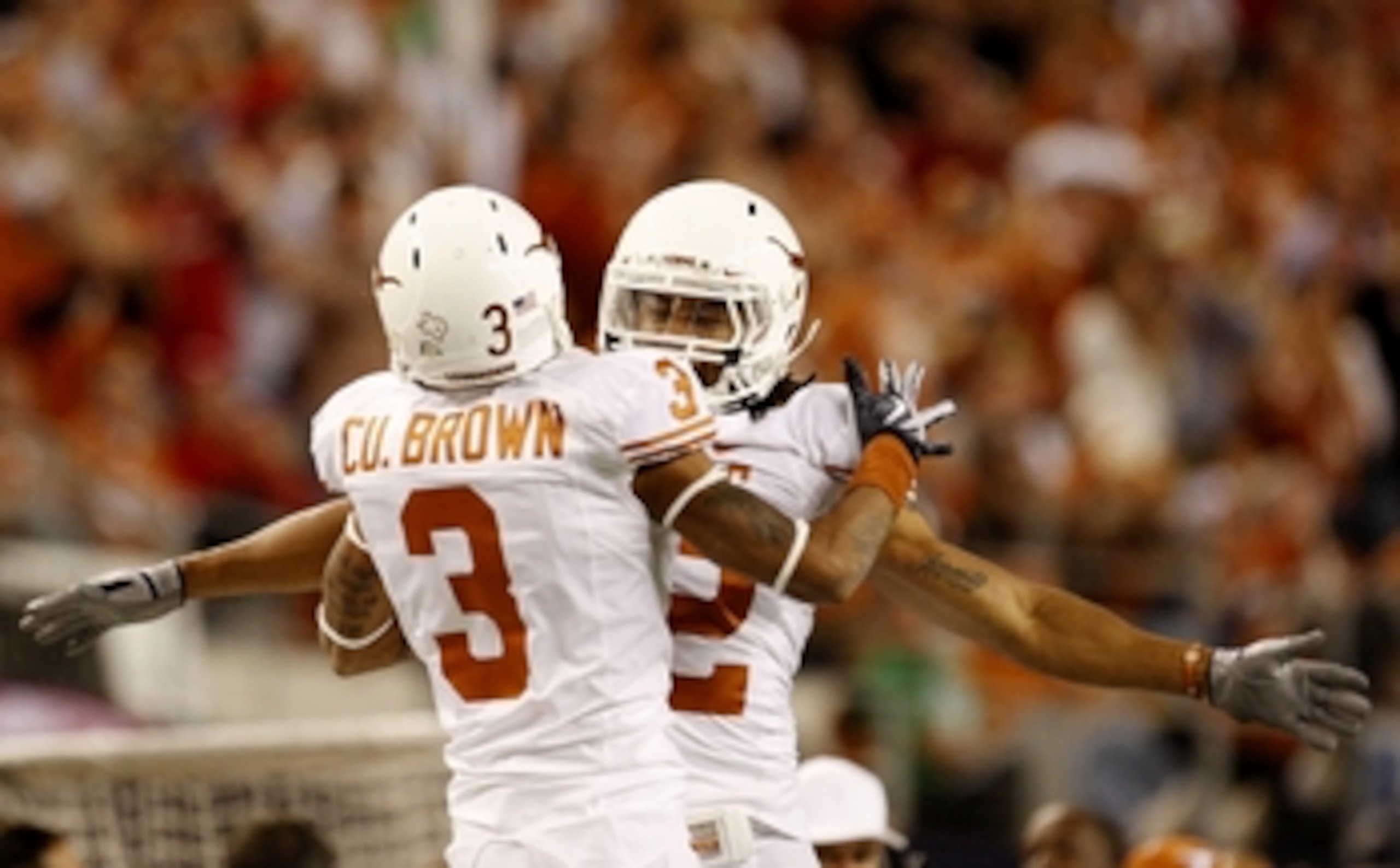 ARLINGTON, TX - DECEMBER 5:  Curtis Brown #3 and Earl Thomas #12 of the Texas Longhorns celebrate breaking up a pass against the Nebraska Cornhuskers in the third quarter at Cowboys Stadium on December 5, 2009 in Arlington, Texas.  (Photo by Ronald Martin
