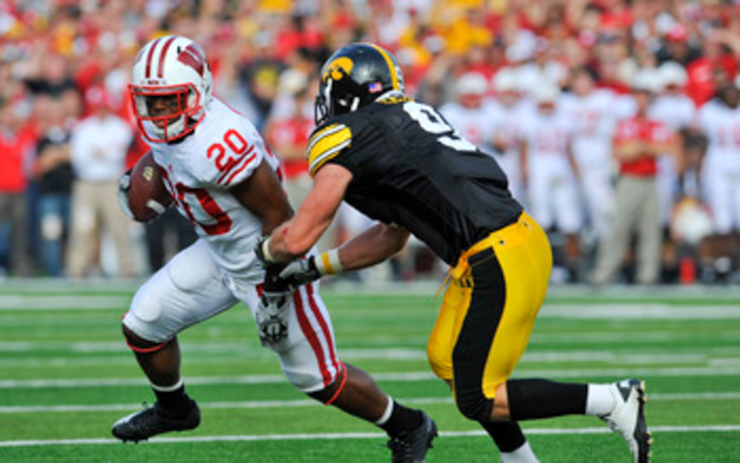 IOWA CITY, IA - OCTOBER 23: Defensive back Tyler Sash #9 of the University of Iowa Hawkeyes closes in on running back James White #20 of the Wisconsin Badgers as he rushes for yards during the first half of play at Kinnick Stadium on October 23, 2010 in I
