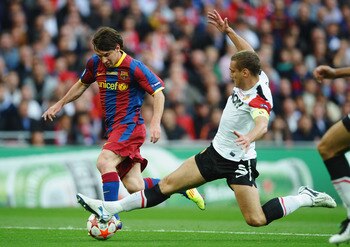 LONDON, ENGLAND - MAY 28:  Lionel Messi of FC Barcelona (L) is challenged by Nemanja Vidic of Manchester United during the UEFA Champions League final between FC Barcelona and Manchester United FC at Wembley Stadium on May 28, 2011 in London, England.  (P