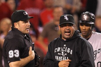 ANAHEIM, CA - MAY 11:  Manager Ozzie Guillen and Alexei Ramirez #10 of the Chicago White Sox argue with home plate umpire Dan Bellino after Bellino called Ramirez out for batter's interference to end the eighth inning against the Los Angeles Angels of Ana