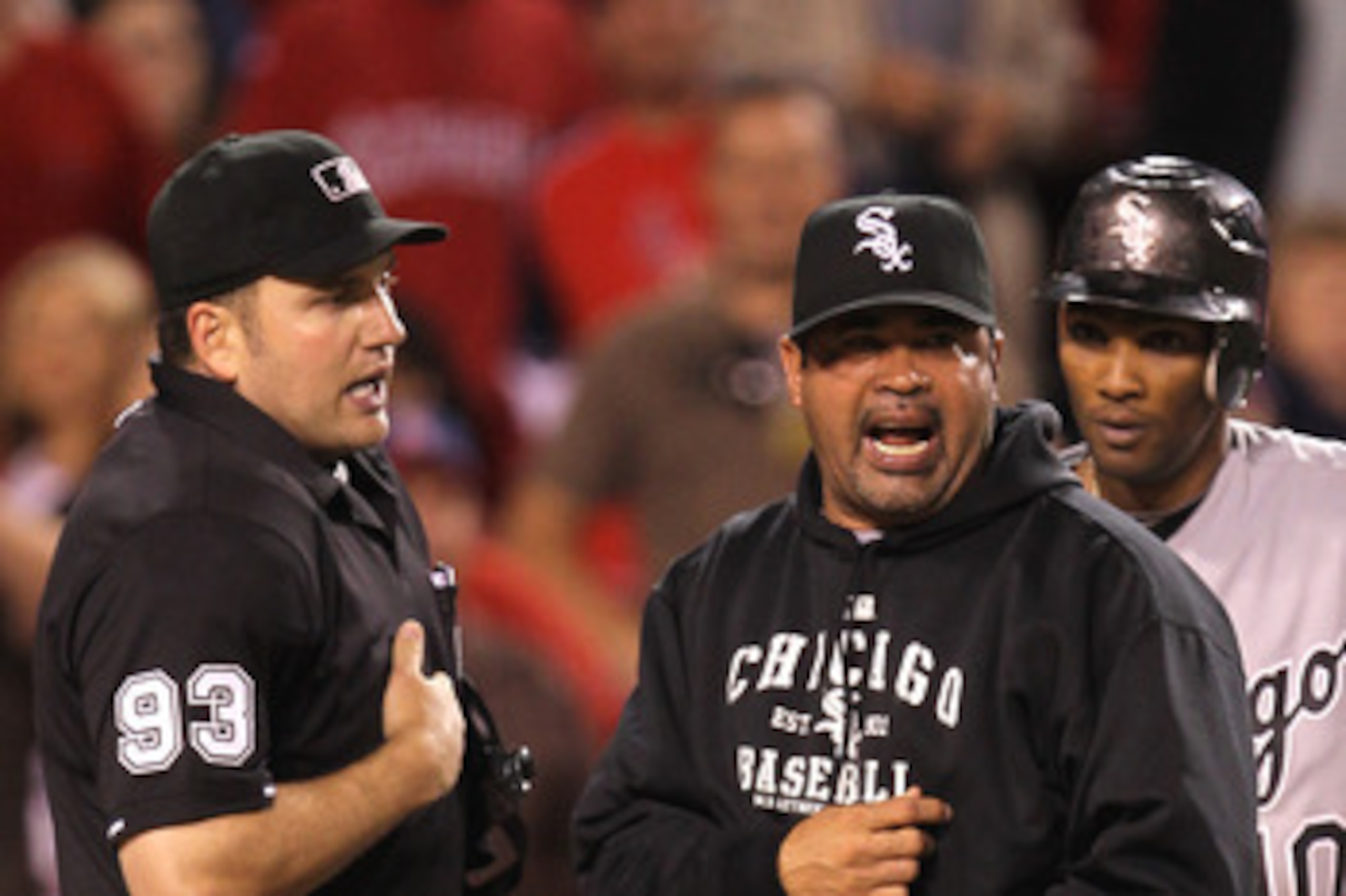 ANAHEIM, CA - MAY 11:  Manager Ozzie Guillen and Alexei Ramirez #10 of the Chicago White Sox argue with home plate umpire Dan Bellino after Bellino called Ramirez out for batter's interference to end the eighth inning against the Los Angeles Angels of Ana