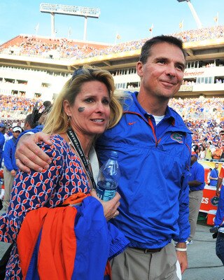 TAMPA, FL - JANUARY 1:  Coach Urban Meyer of the Florida Gators hugs his wife, Shelley, after play against the Penn State Nittany Lions January 1, 2011 in the 25th Outback Bowl at Raymond James Stadium in Tampa, Florida.  (Photo by Al Messerschmidt/Getty 
