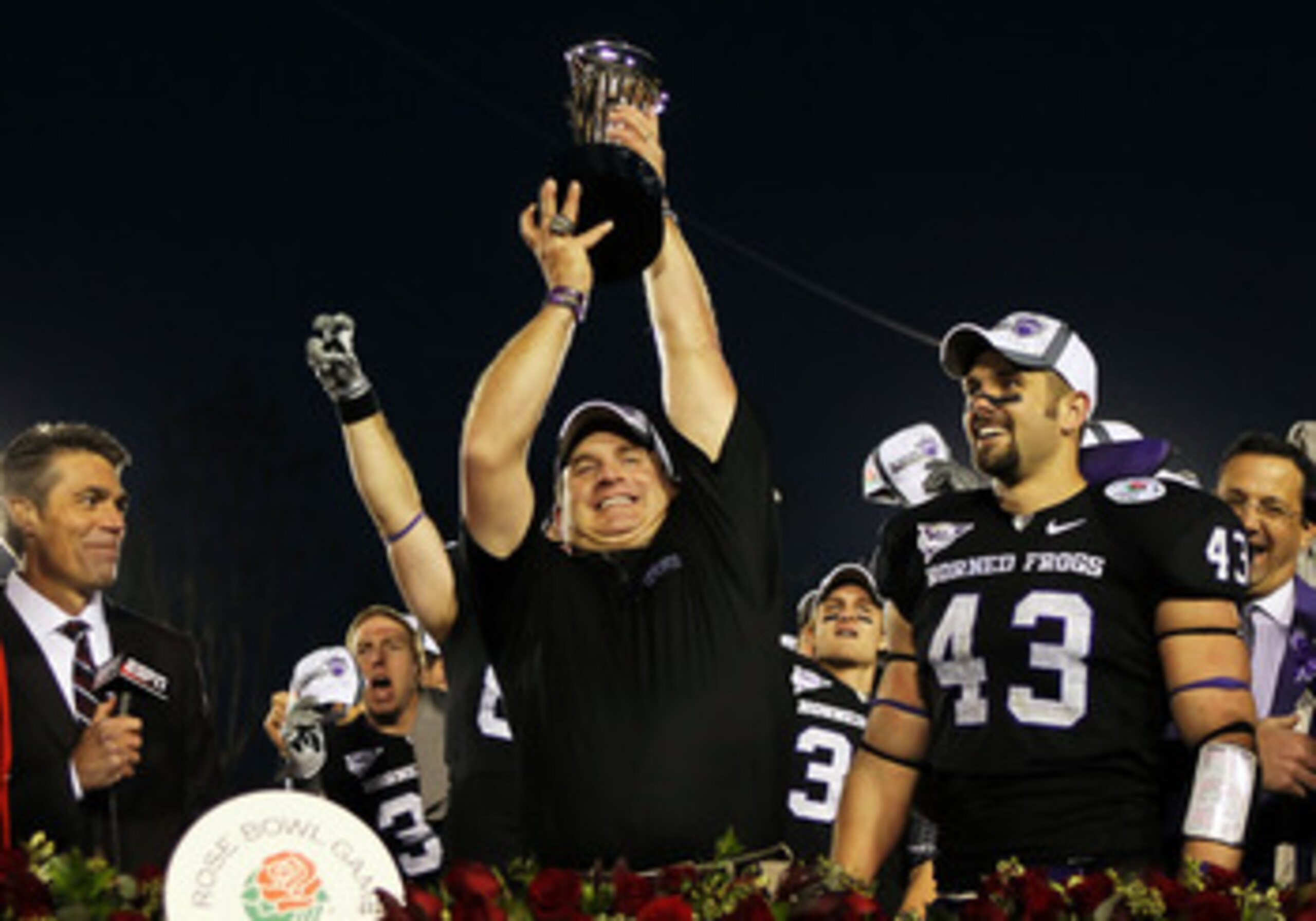 PASADENA, CA - JANUARY 01:  Head coach Gary Patterson of the TCU Horned Frogs holds the Rose Bowl Championship Trophy after defeating the Wisconsin Badgers 21-19 in the 97th Rose Bowl game on January 1, 2011 in Pasadena, California.  (Photo by Jeff Gross/