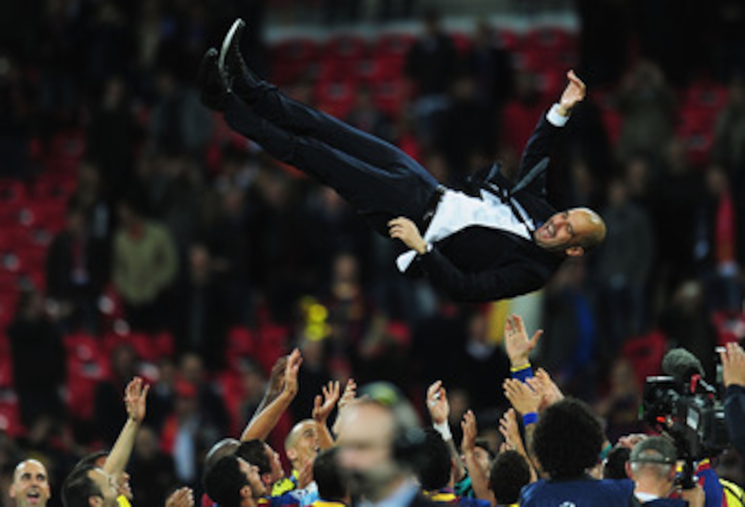 LONDON, ENGLAND - MAY 28:  Josep Guardiola manager of FC Barcelona is thrown in the air as Barcelona celebrate victory in UEFA Champions League final between FC Barcelona and Manchester United FC at Wembley Stadium on May 28, 2011 in London, England.  (Ph