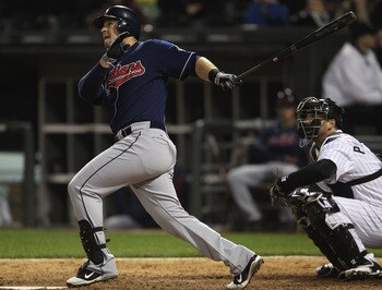 CHICAGO, IL - MAY 19: Matt LaPorta #7 of the Cleveland Indians hits a solo home run in the 9th inning in front of A.J. Pierzynski #12 of the Chicago White Sox at U.S. Cellular Field on May 19, 2011 in Chicago, Illinois. The White Sox defeated the Indians 