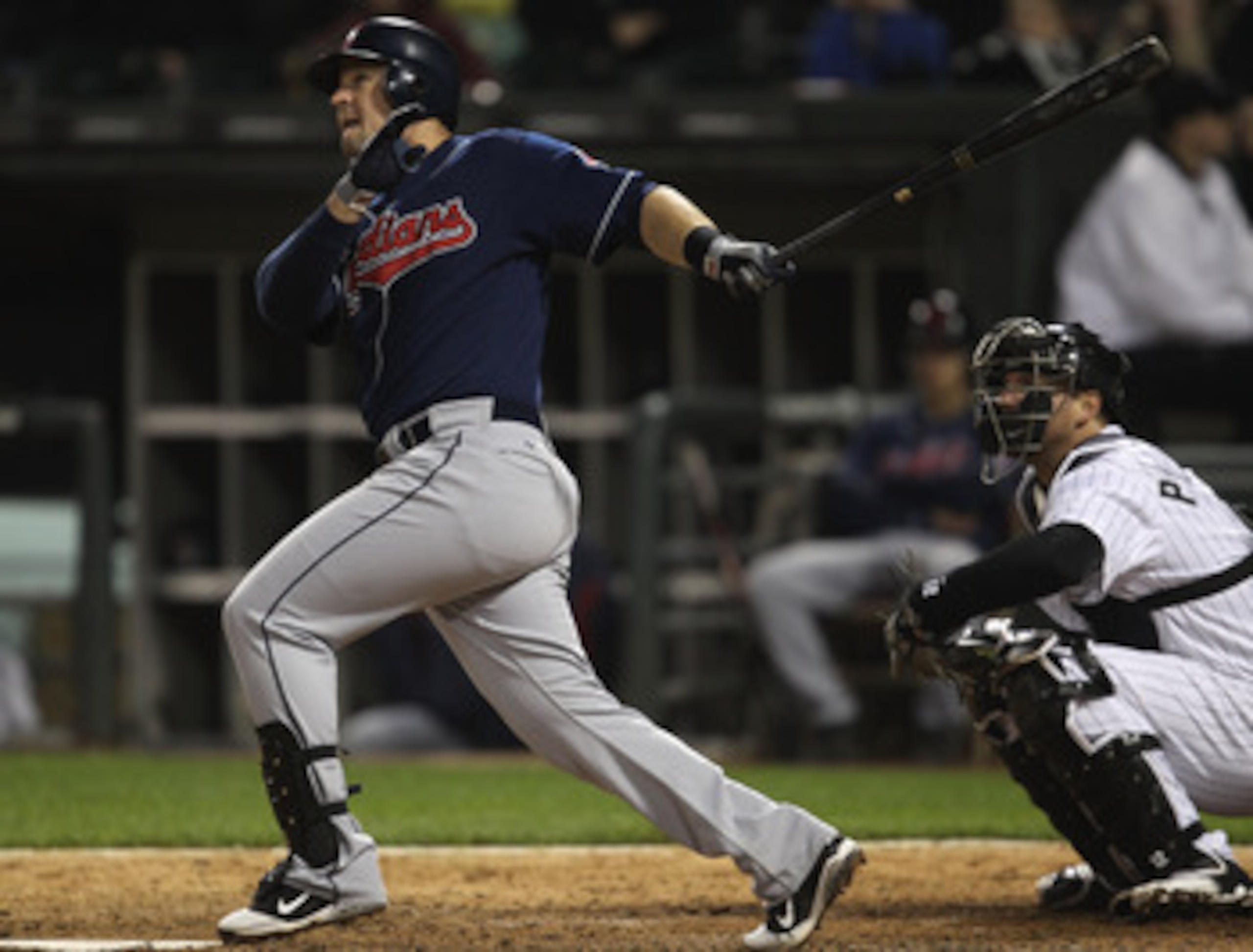 CHICAGO, IL - MAY 19: Matt LaPorta #7 of the Cleveland Indians hits a solo home run in the 9th inning in front of A.J. Pierzynski #12 of the Chicago White Sox at U.S. Cellular Field on May 19, 2011 in Chicago, Illinois. The White Sox defeated the Indians 