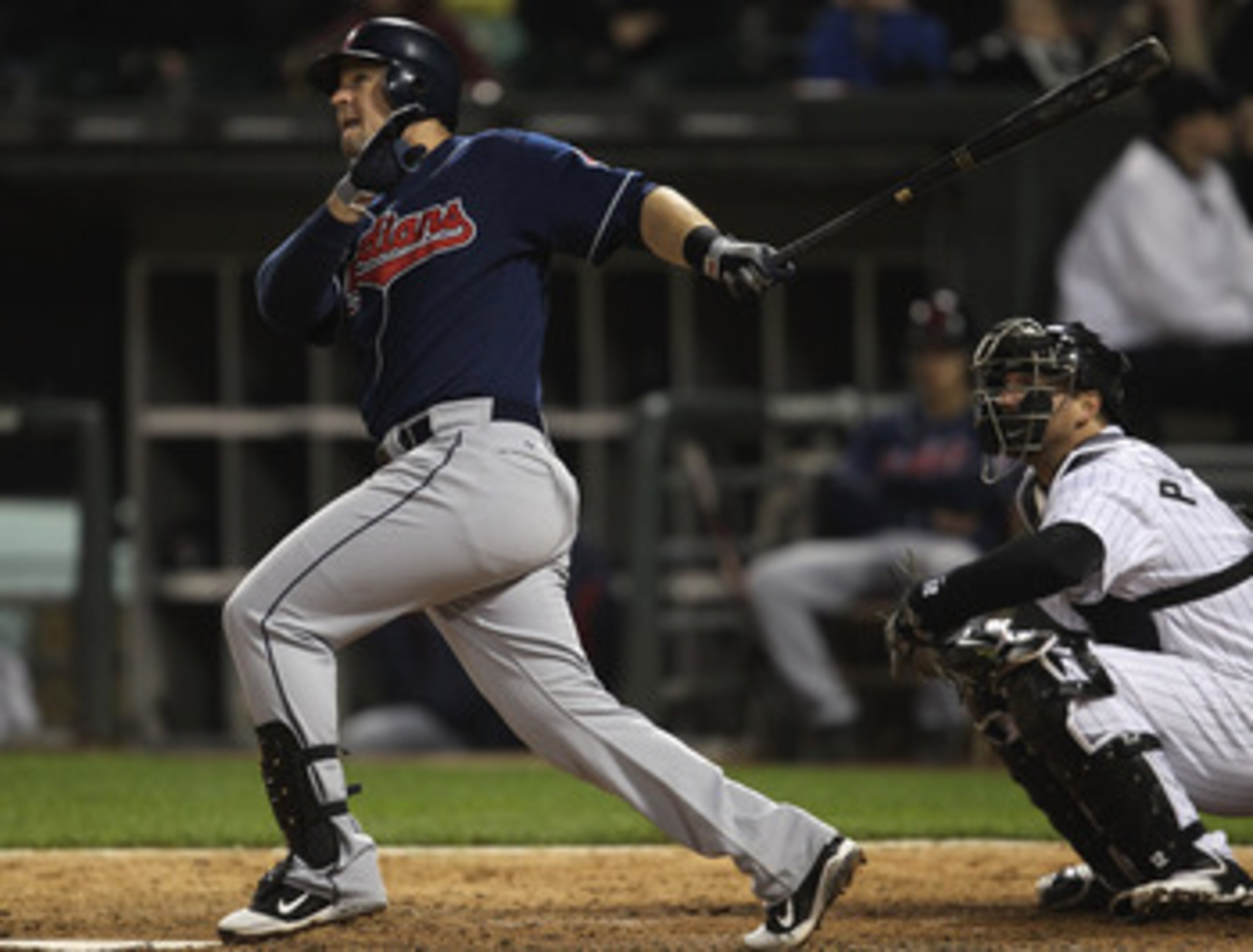 CHICAGO, IL - MAY 19: Matt LaPorta #7 of the Cleveland Indians hits a solo home run in the 9th inning in front of A.J. Pierzynski #12 of the Chicago White Sox at U.S. Cellular Field on May 19, 2011 in Chicago, Illinois. The White Sox defeated the Indians 