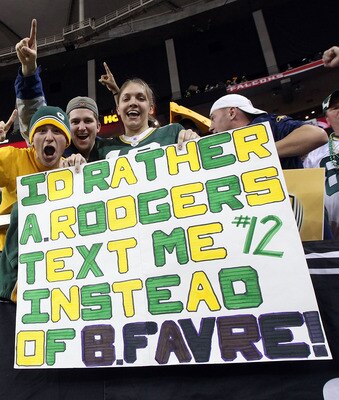 ATLANTA, GA - JANUARY 15:  Fans of the Green Bay Packers hold up a sign which reads 'I'd Rather Aaron Rodgers text me instead of Brett Favre after the Packers defeated the Atlanta Falcons 48-21 during their 2011 NFC divisional playoff game at Georgia Dome