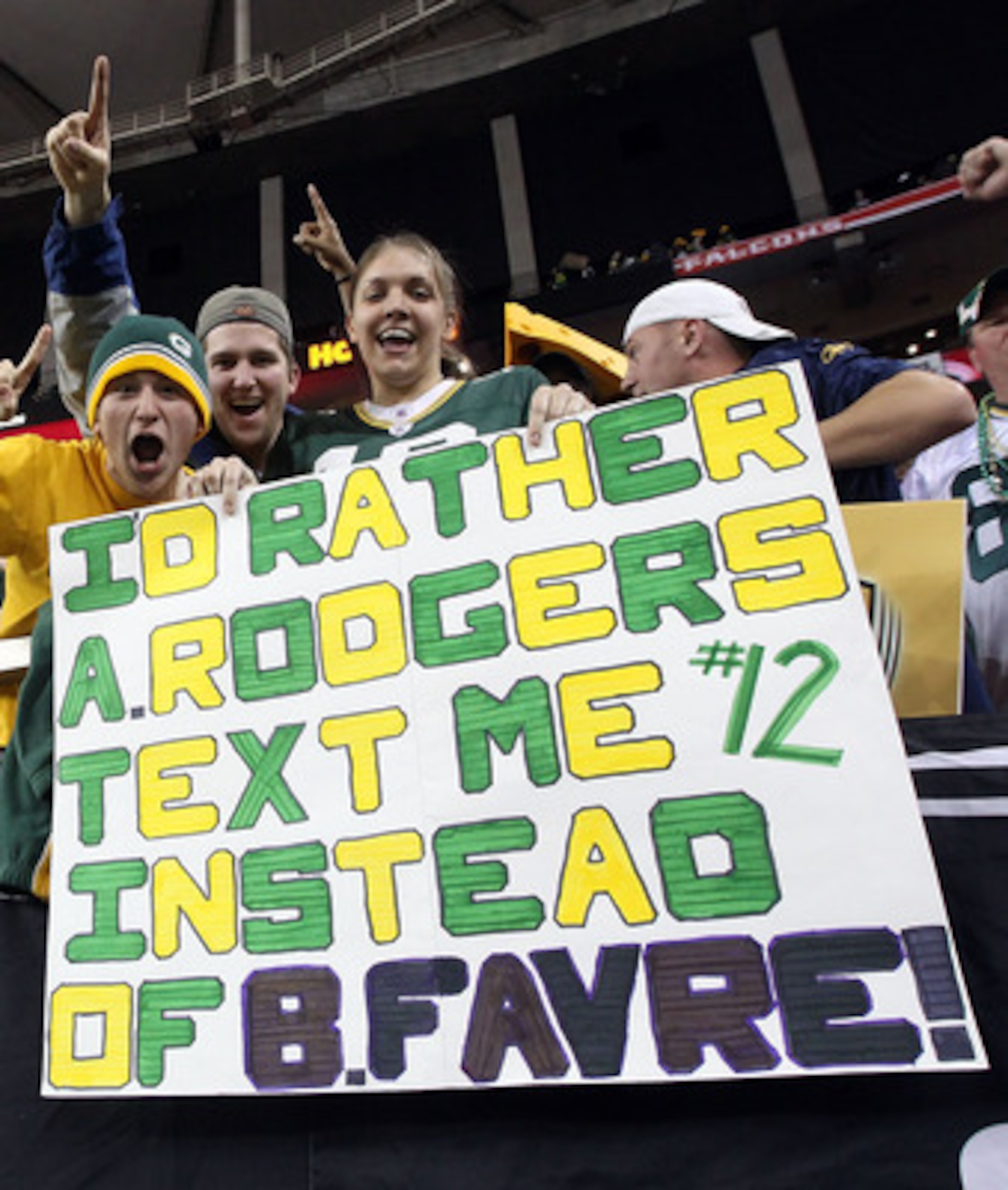ATLANTA, GA - JANUARY 15:  Fans of the Green Bay Packers hold up a sign which reads 'I'd Rather Aaron Rodgers text me instead of Brett Favre after the Packers defeated the Atlanta Falcons 48-21 during their 2011 NFC divisional playoff game at Georgia Dome