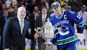 VANCOUVER, CANADA - MAY 24:  NHL Deputy Commissioner Bill Daly and Captain Henrik Sedin #33 of the Vancouver Canucks pose with the Clarence Campbell Bowl after the Vancouver Canucks defeated the San Jose Sharks 3-2 in double-overtime in Game Five to win t
