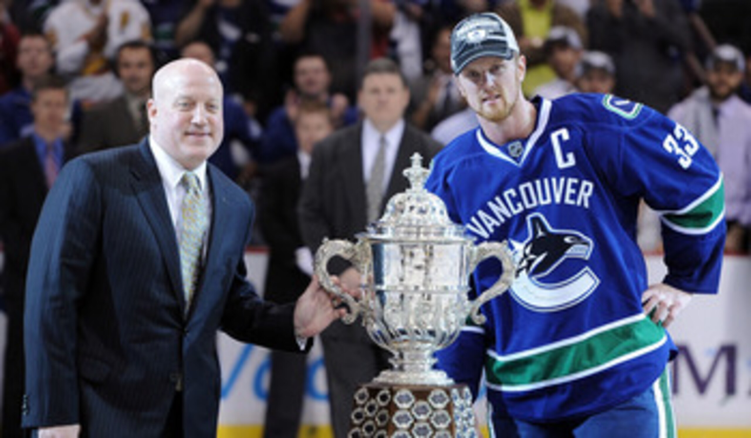 VANCOUVER, CANADA - MAY 24:  NHL Deputy Commissioner Bill Daly and Captain Henrik Sedin #33 of the Vancouver Canucks pose with the Clarence Campbell Bowl after the Vancouver Canucks defeated the San Jose Sharks 3-2 in double-overtime in Game Five to win t