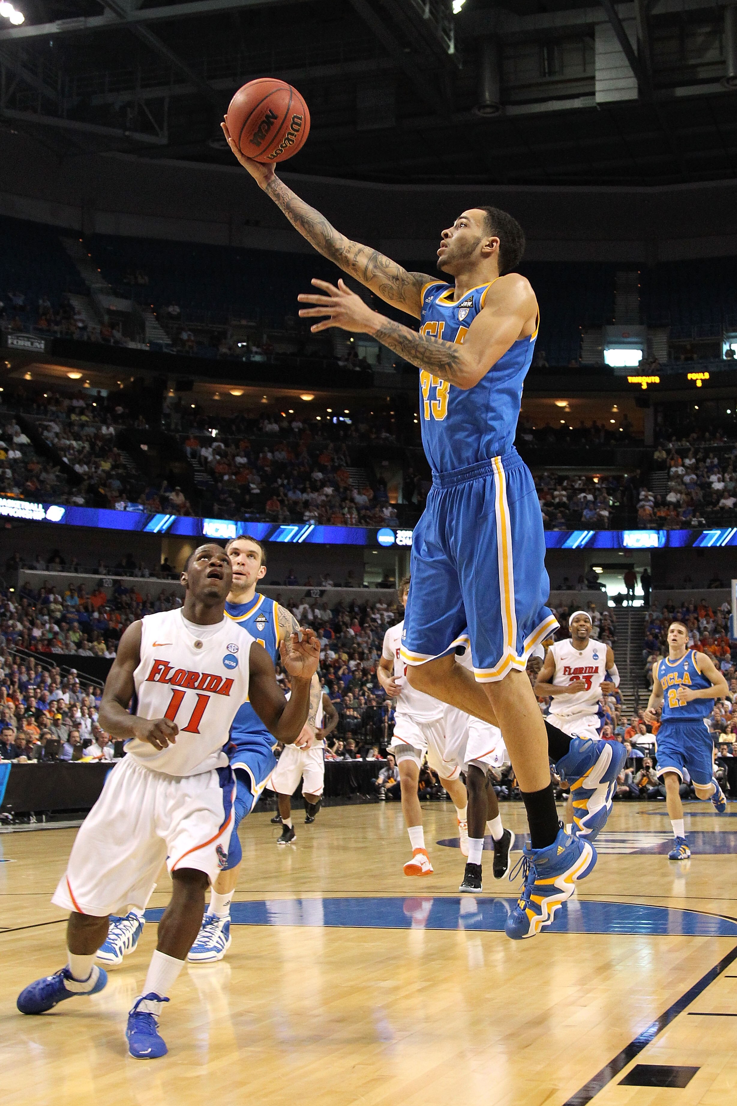TAMPA, FL - MARCH 19:  Tyler Honeycutt #23 of the UCLA Bruins drives for a shot attempt against Erving Walker #11 of the Florida Gators during the third round of the 2011 NCAA men's basketball tournament at St. Pete Times Forum on March 19, 2011 in Tampa,