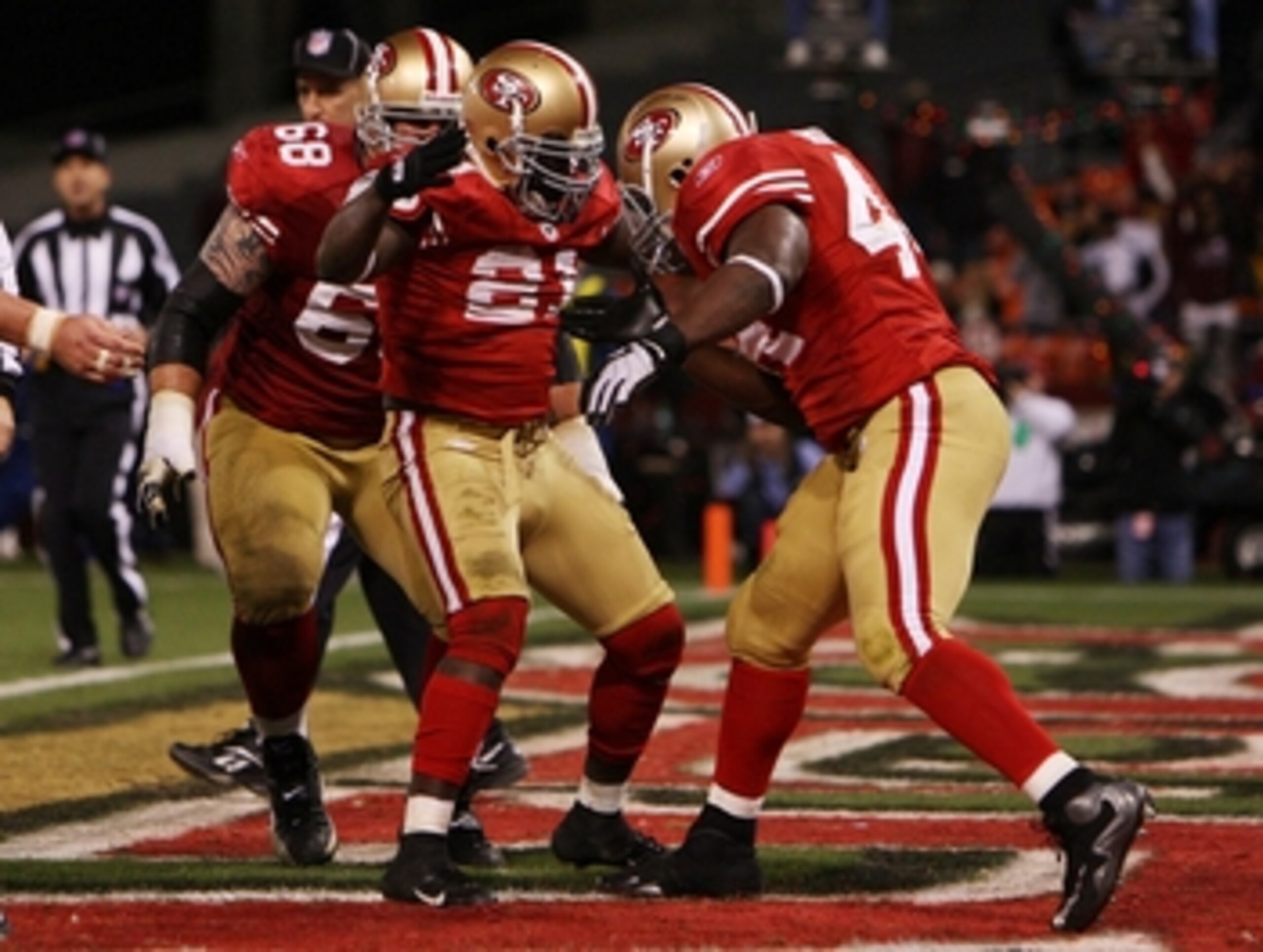SAN FRANCISCO - DECEMBER 14:  (C) Frank Gore #21 of the San Francisco 49ers celebrates with teammates Adam Snyder #68 and  Moran Norris #44 after Gore scored a two-yard touchdown against the Arizona Cardinals in the fourth quarter at Candlestick Park on D