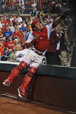 PHILADELPHIA, PA - MAY 23: Carlos Ruiz #51 of the Philadelphia Phillies jumps into the backstop to catch a foul ball during the game against the Cincinnati Reds at Citizens Bank Park on May 23, 2011 in Philadelphia, Pennsylvania. The Phillies won 10-3. (P PHILADELPHIA, PA - MAY 23: Carlos Ruiz #51 of the Philadelphia Phillies jumps into the backstop to catch a foul ball during the game against the Cincinnati Reds at Citizens Bank Park on May 23, 2011 in Philadelphia, Pennsylvania. The Phillies won 10-3. (P