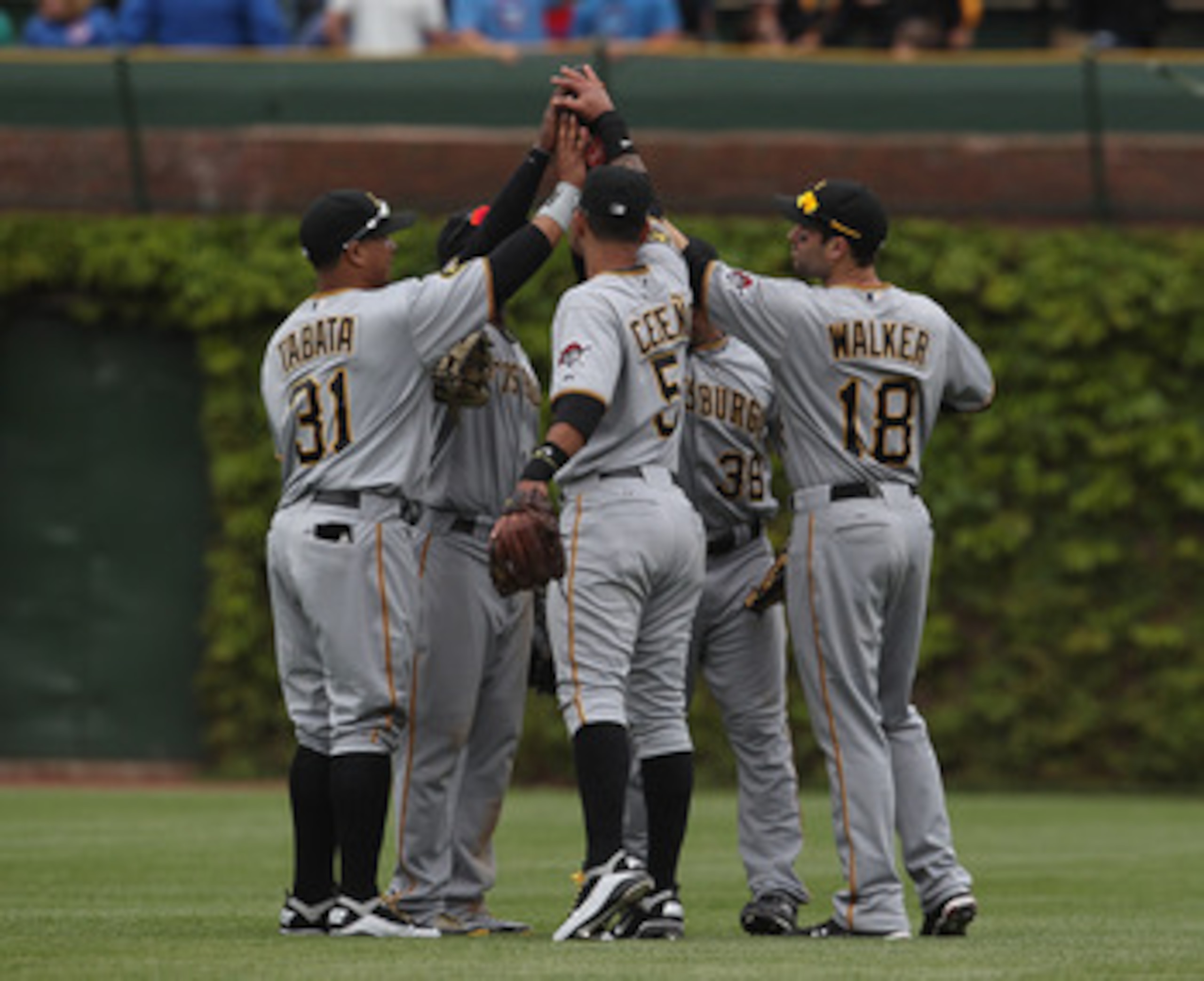 CHICAGO, IL - MAY 27: (L-R) Jose Tabata #31, Andrew McCutchen #22, Ronny Cedeno #5, Xavier Paul #38 and Neil Walker #18 of the Pittsburgh Pirates celebrate a win over the Chicago Cubs at Wrigley Field on May 27, 2011 in Chicago, Illinois. The Pirates defe
