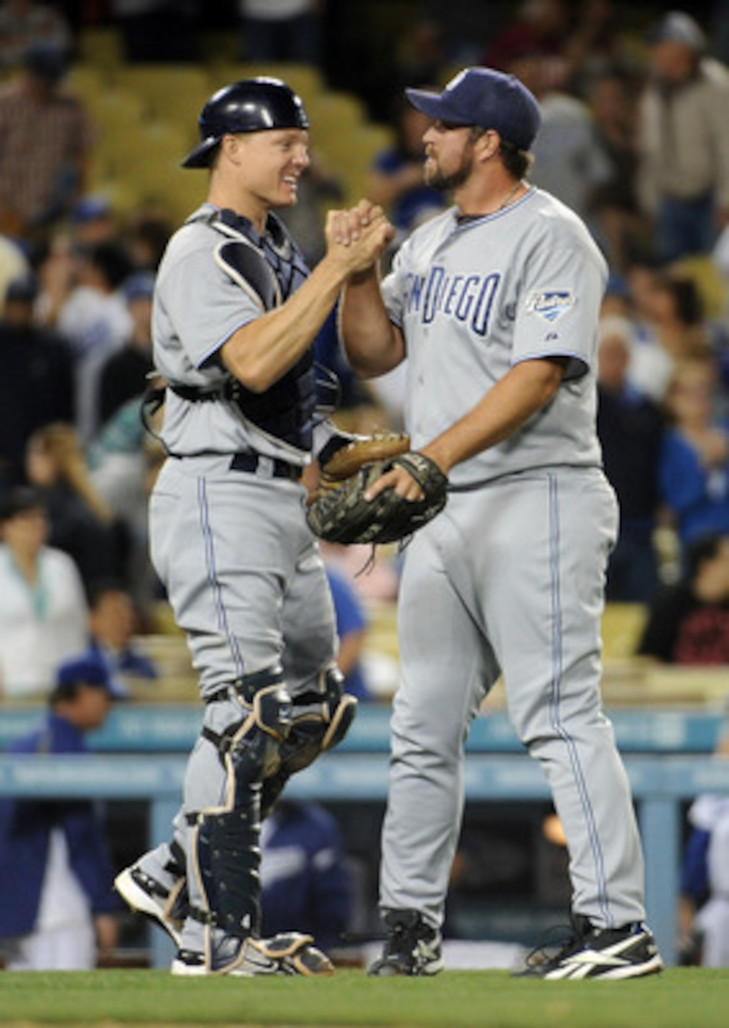 LOS ANGELES, CA - APRIL 30:  Nick Hundley and Heath Bell #21 of the San Diego Padres celebrate a 5-2 win over the Los Angeles Dodgers after the ninth inning at Dodger Stadium on April 30, 2011 in Los Angeles, California.  (Photo by Harry How/Getty Images)