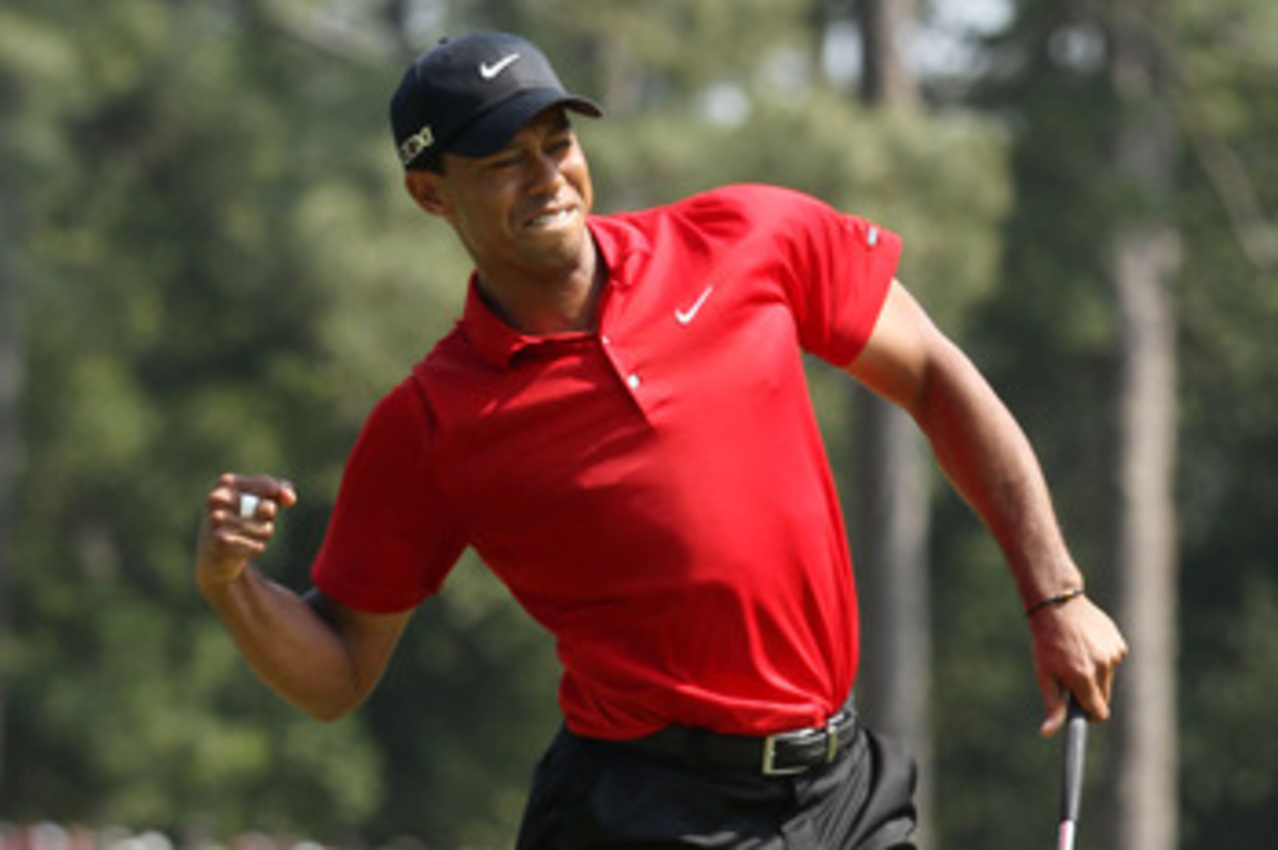 AUGUSTA, GA - APRIL 10:  Tiger Woods celebrates after holing a putt for eagle on the eighth green during the final round of the 2011 Masters Tournament on April 10, 2011 in Augusta, Georgia.  (Photo by Andrew Redington/Getty Images)