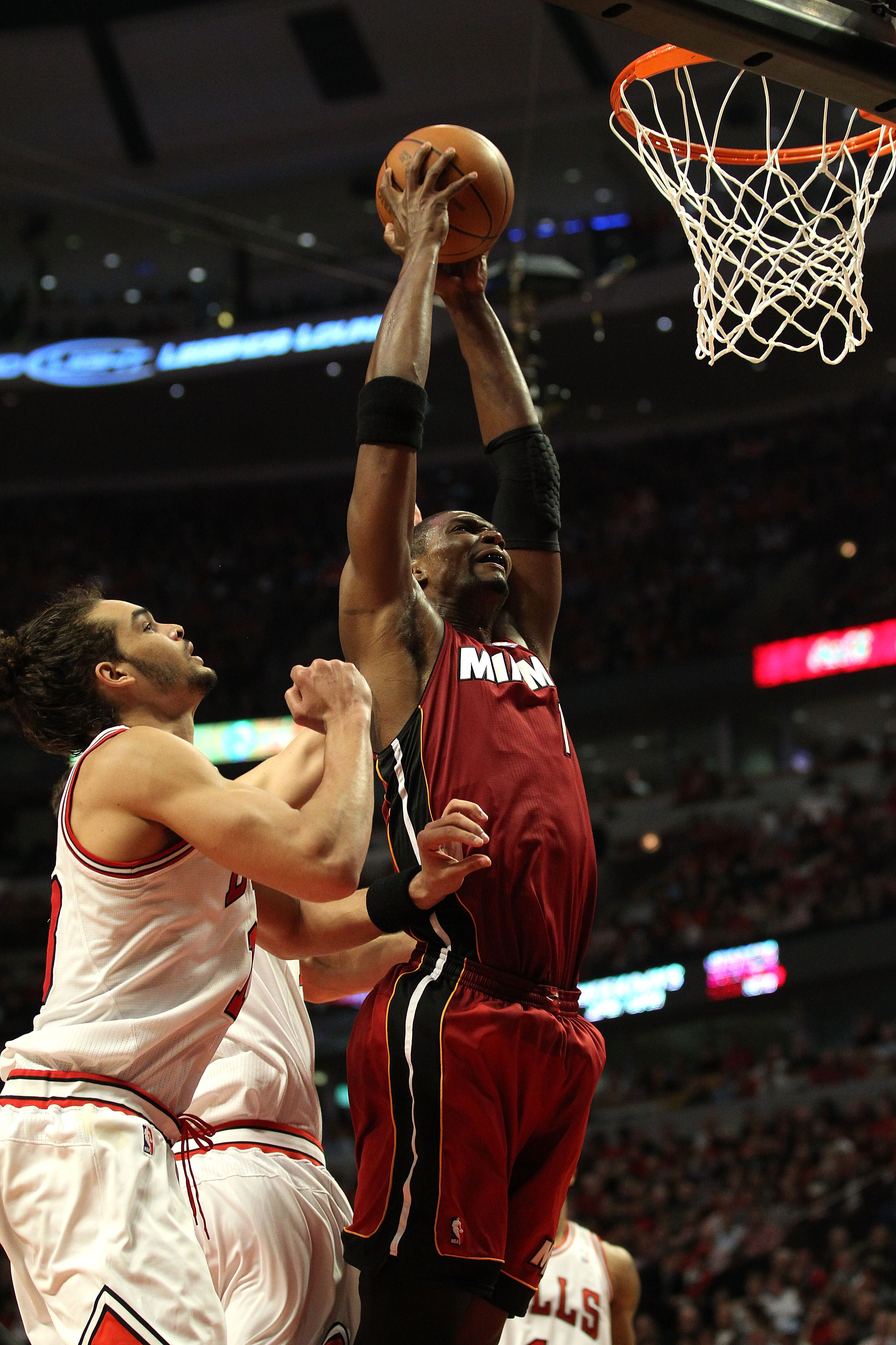 CHICAGO, IL - MAY 26:  Chris Bosh #1 of the Miami Heat dunks against Joakim Noah #13 of the Chicago Bulls in Game Five of the Eastern Conference Finals during the 2011 NBA Playoffs on May 26, 2011 at the United Center in Chicago, Illinois. NOTE TO USER: U