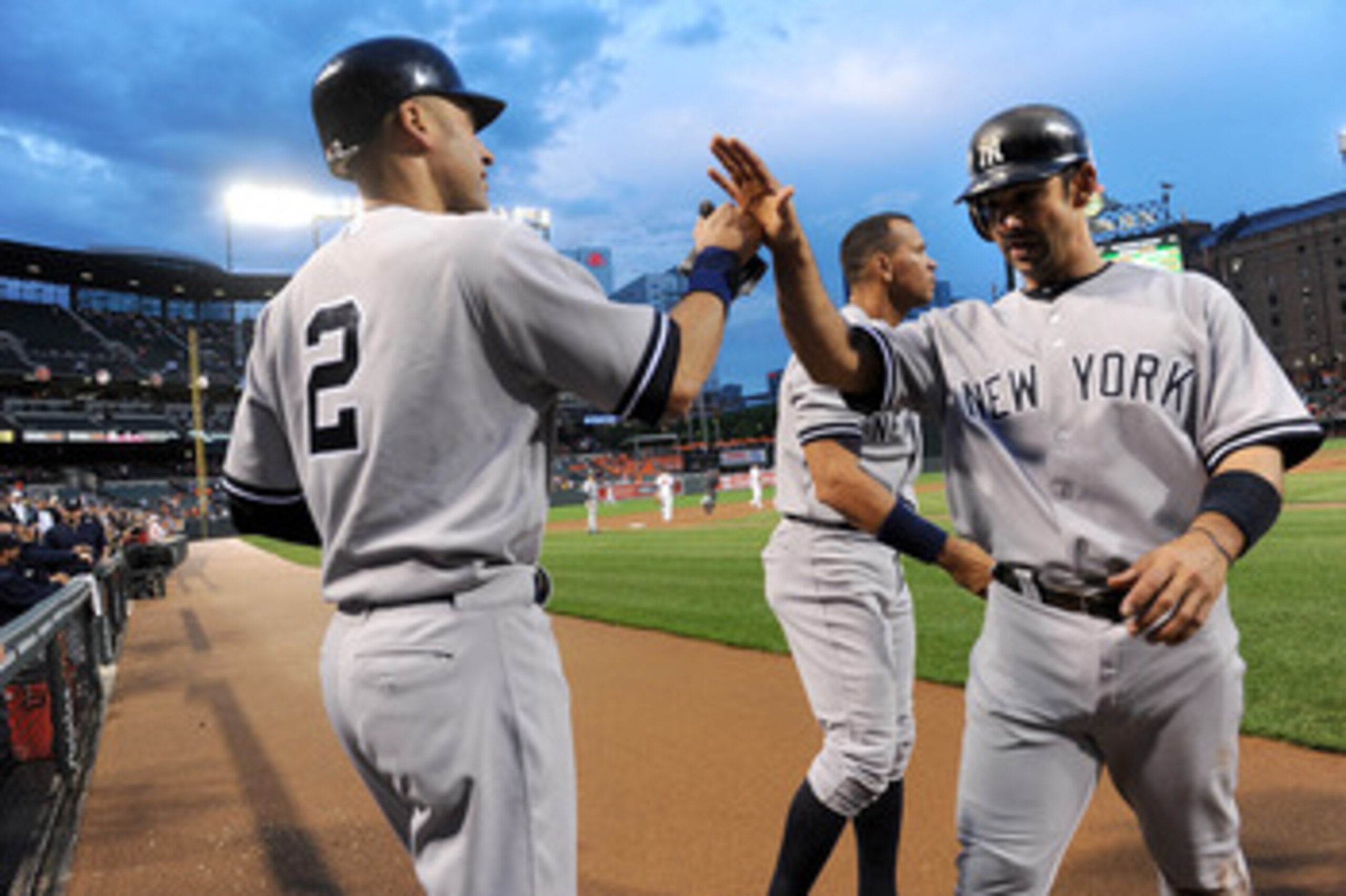 BALTIMORE, MD - MAY 19:  Jorge Posada #20 of the New York Yankees is congratulated by Derek Jeter #2 and Alex Rodriguez #13 after scoring in the first inning against the Baltimore Orioles at Oriole Park at Camden Yards on May 19, 2011 in Baltimore, Maryla