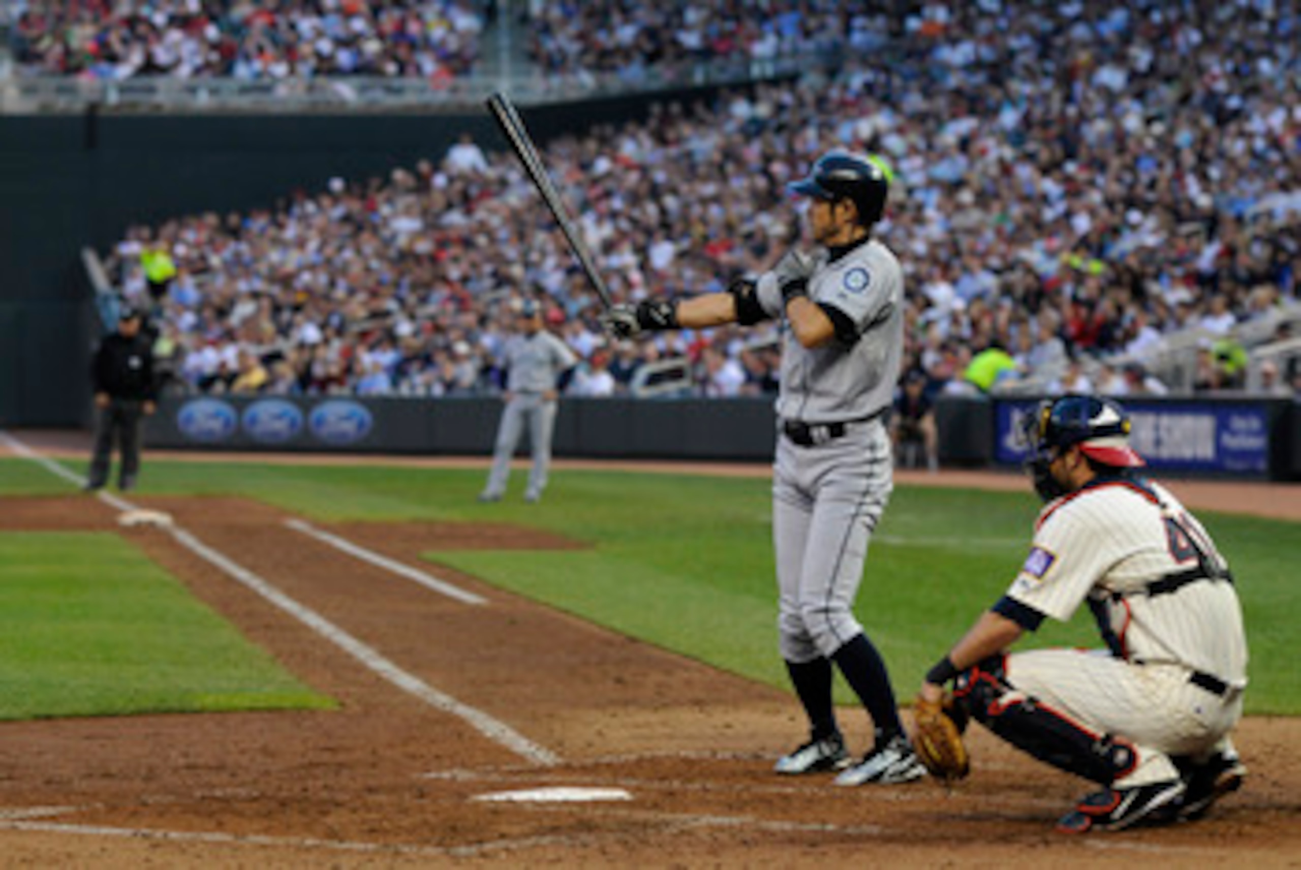 MINNEAPOLIS, MN - MAY 23: Ichiro Suzuki #51 of the Seattle Mariners bats as catcher Drew Butera #41 of the Minnesota Twins defends home plate during their game on May 23, 2011 at Target Field in Minneapolis, Minnesota. The Rockies won 6-5. (Photo by Hanna