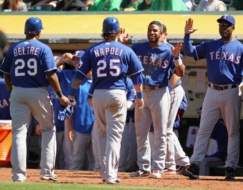OAKLAND, CA - APRIL 30: Adrian Beltre #29 and Mike Napoli #25 of the Texas Rangers are congratulated by teammates after they scored on a double by Yorvit Torrealba #8 of the Texas Rangers in the eighth inning of their game against the Oakland Athletics a OAKLAND, CA - APRIL 30: Adrian Beltre #29 and Mike Napoli #25 of the Texas Rangers are congratulated by teammates after they scored on a double by Yorvit Torrealba #8 of the Texas Rangers in the eighth inning of their game against the Oakland Athletics a
