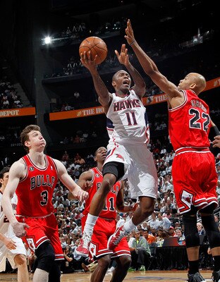 ATLANTA, GA - MAY 12:  Jamal Crawford #11 of the Atlanta Hawks drives against Omer Asik #3 and Taj Gibson #22 of the Chicago Bulls in Game Six of the Eastern Conference Semifinals in the 2011 NBA Playoffs at Phillips Arena on May 12, 2011 in Atlanta, Geor