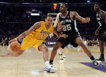 LOS ANGELES, CA - APRIL 12:  Shannon Brown #12 of the Los Angeles Lakers dribbles on James Anderson #25 of the San Antonio Spurs during the game at Staples Center on April 12, 2011 in Los Angeles, California.  NOTE TO USER: User expressly acknowledges and