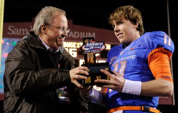 LAS VEGAS, NV - DECEMBER 22:  MAACO President Dave Lapps (L) gives the most valuable player trophy to quarterback Kellen Moore #11 of the Boise State Broncos after the team's 26-3 victory over the Utah Utes in the MAACO Bowl Las Vegas at Sam Boyd Stadium 