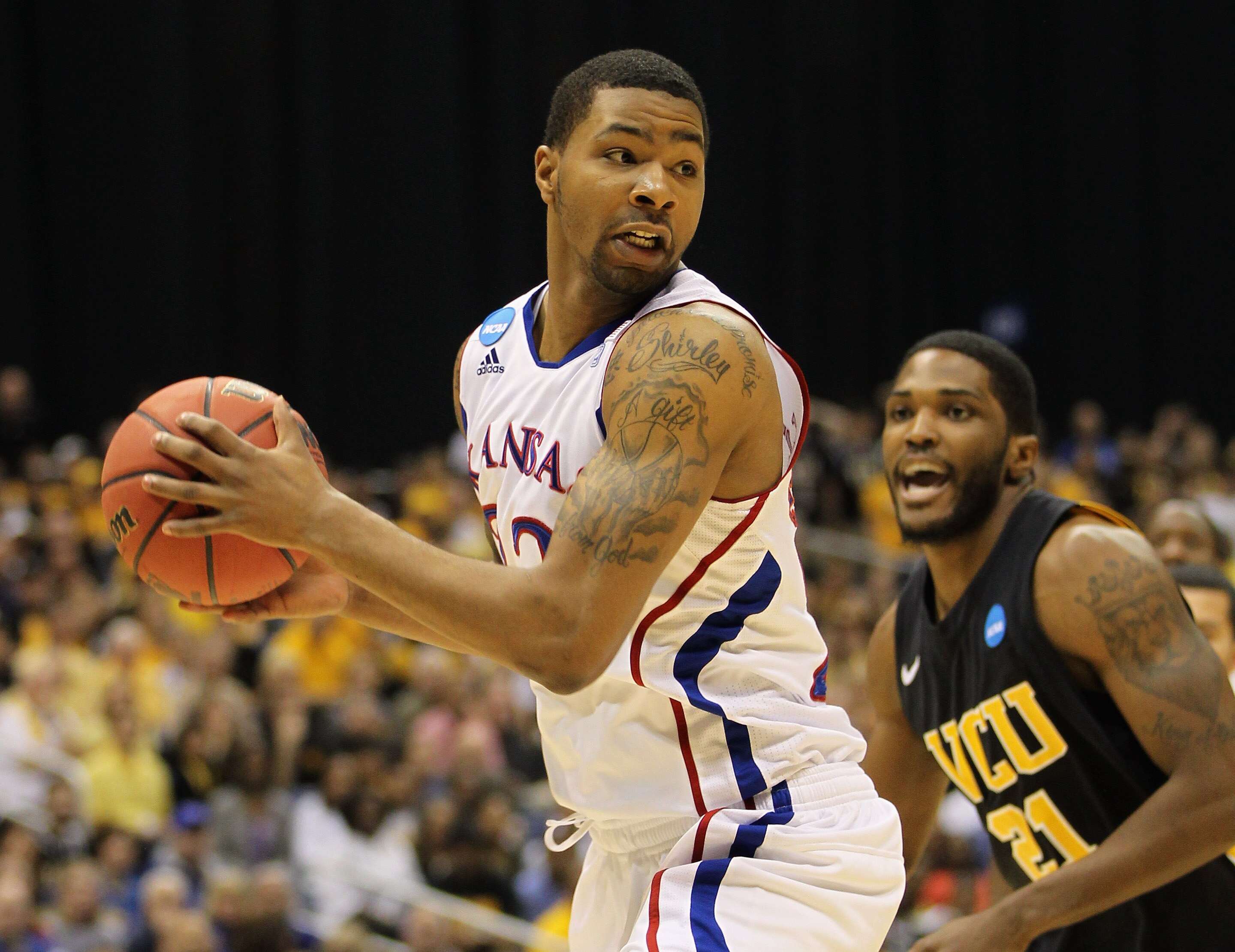 SAN ANTONIO, TX - MARCH 27:  Marcus Morris #22 of the Kansas Jayhawks handles the ball against Jamie Skeen #21 of the Virginia Commonwealth Rams during the southwest regional final of the 2011 NCAA men's basketball tournament at the Alamodome on March 27,