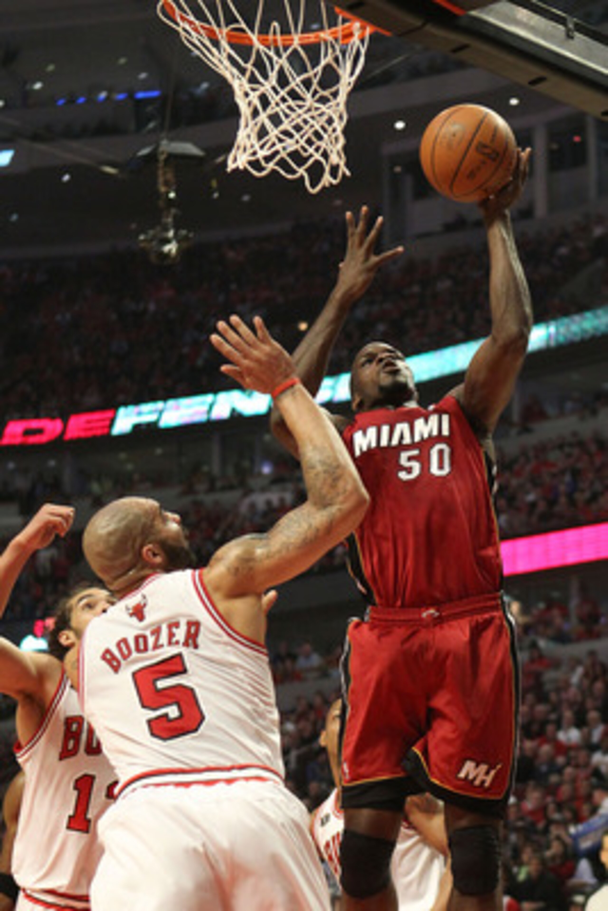 CHICAGO, IL - MAY 26:  Joel Anthony #50 of the Miami Heat attempts a shot against Carlos Boozer #5 of the Chicago Bulls in Game Five of the Eastern Conference Finals during the 2011 NBA Playoffs on May 26, 2011 at the United Center in Chicago, Illinois. N